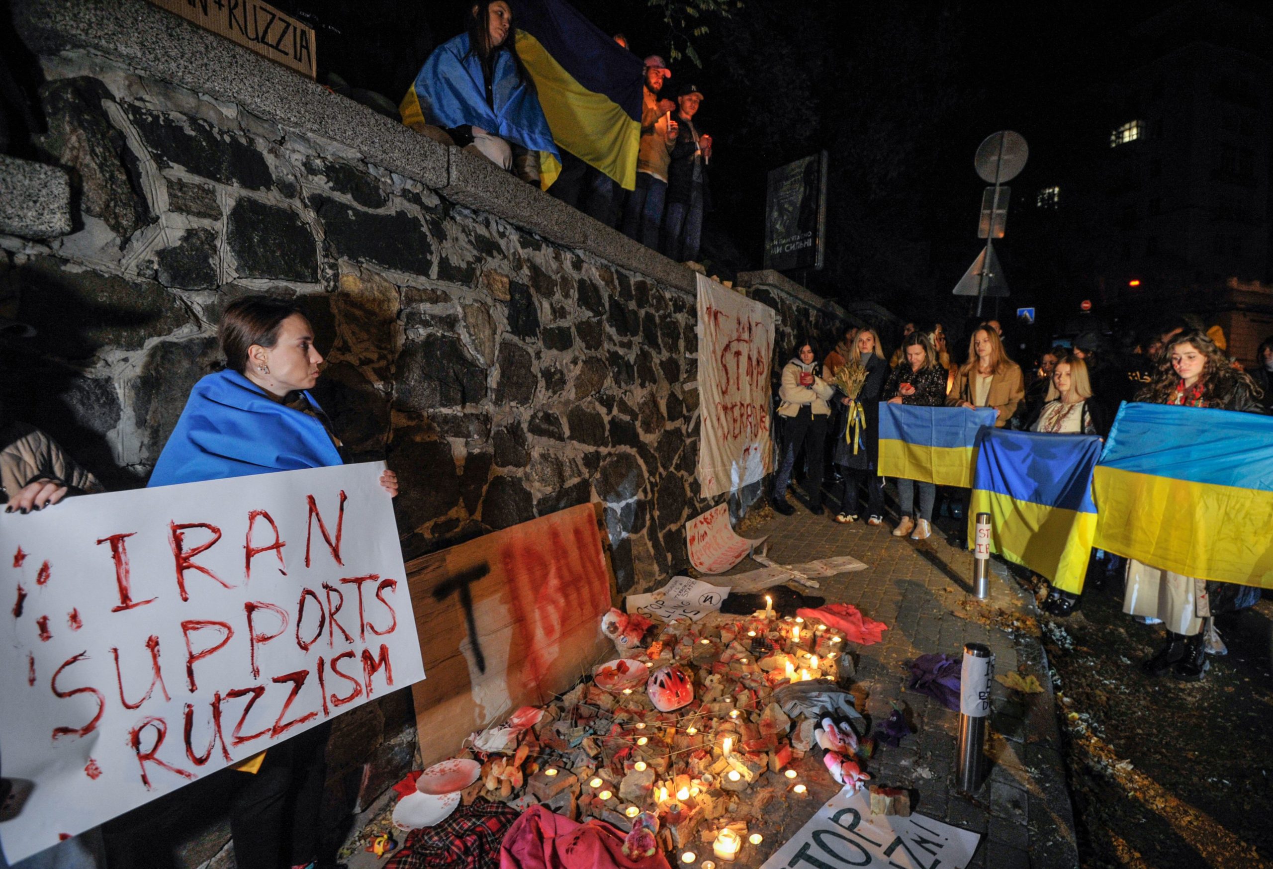 People demonstrate outside the Iranian embassy in Ukraine on October 17, 2022 in Kyiv, after the city was hit by swarms of kamikaze drones sold by Iran to Russia, leaving at least three dead. 