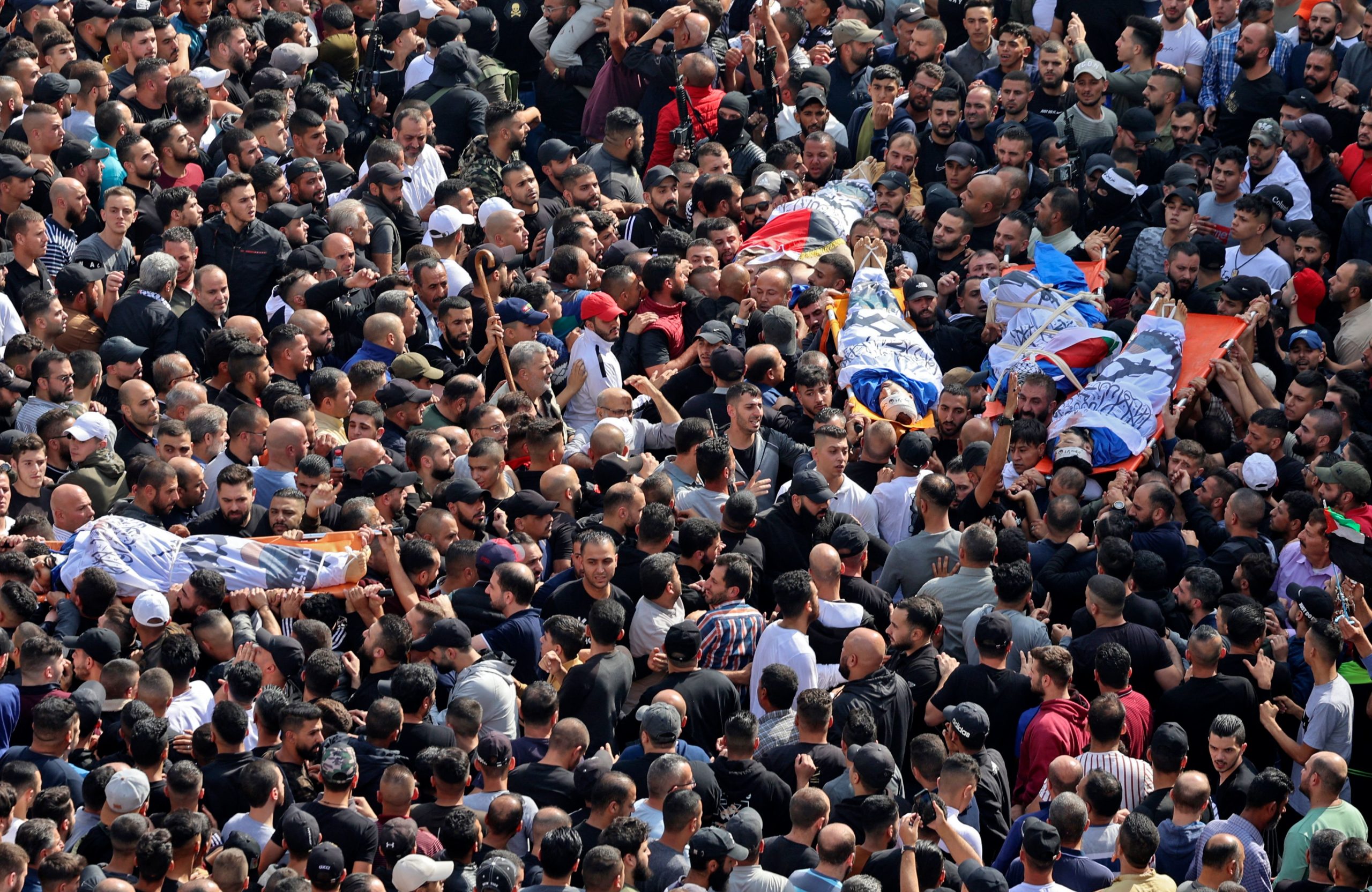 Mourners attend the funeral of Palestinians killed in an overnight Israeli raid, in the occupied West Bank city of Nablus on October 25, 2022. - Six Palestinians were killed in sweeping Israeli raids in the occupied West Bank, the Palestinian Health Ministry reported, in what the army said was an assault targeting the emerging "Lion's Den" armed group. 
