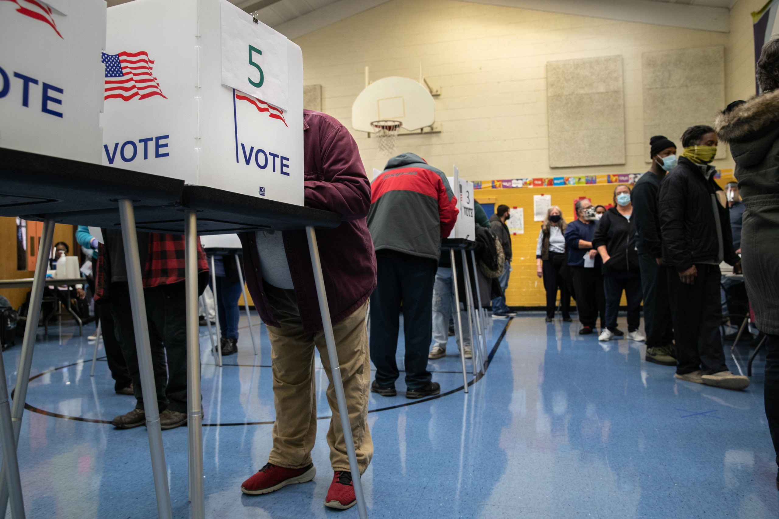 Voters fill out their ballots at a school gymnasium on November 03, 2020 in Lansing, Michigan. After a record-breaking early voting turnout, Americans went to the polls on the last day to cast their vote for incumbent U.S. President Donald Trump or Democratic nominee Joe Biden in the 2020 presidential election. (Photo by John Moore/Getty Images)