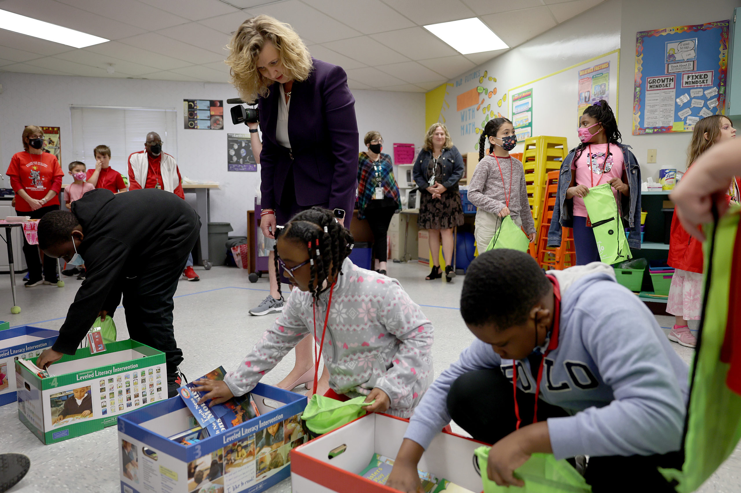 Dr. Vickie L. Cartwright, Superintendent of Broward County Public Schools, helps children find books to be given out for summer reading at Riverside Elementary school as the school district observes A Day of Service and Love in commemoration of the 17 people killed at Marjory Stoneman Douglas High School on February 14, 2022 in Coral Springs, Florida. Four years ago on February 14, fourteen students and three staff members were killed during a mass shooting at the school located in Parkland, Florida. (Photo by Joe Raedle/Getty Images)