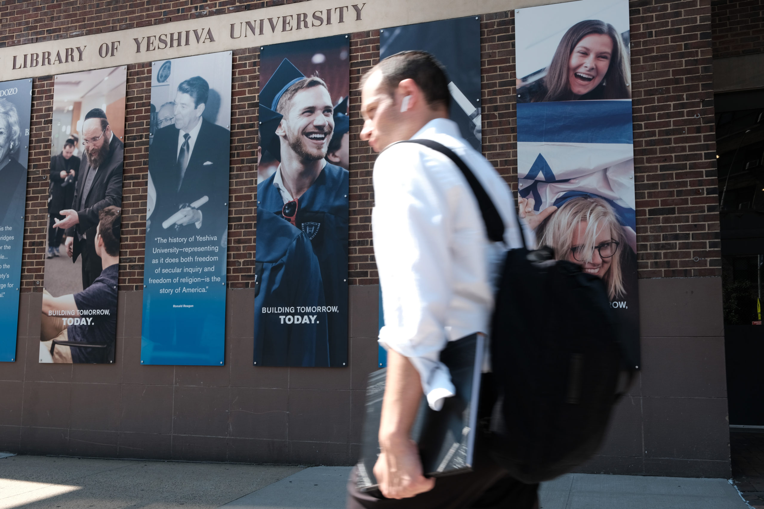 People walk by the campus of Yeshiva University in New York City on August 30, 2022 in New York City. Yeshiva University on Monday filed an emergency request with the Supreme Court asking it to block a judge’s order that requires the university to recognize an LGBTQ+ student group. The religious and Jewish university stated in court papers that “Yeshiva cannot comply with that order because doing so would violate its sincere religious beliefs about how to form its undergraduate students in Torah values." (Photo by Spencer Platt/Getty Images)