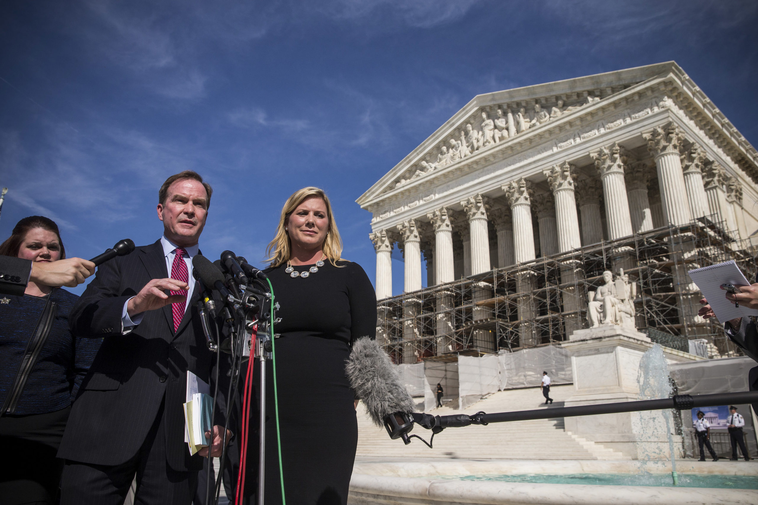 Jennifer Gratz (R), CEO of XIV Foundation and Michigan Attorney General Bill Schuette speak during a press conference outside the Supreme Court after going before the Supreme Court in "Schuette v. Coalition to Defend Affirmative Action" on October 15, 2013 in Washington, DC. The case revolves around affirmative action and whether or not states have the right to ban schools from using race as a consideration in school admissions. Gratz was involved in a previous Supreme Court case involving the same issues. (Photo by Andrew Burton/Getty Images)
