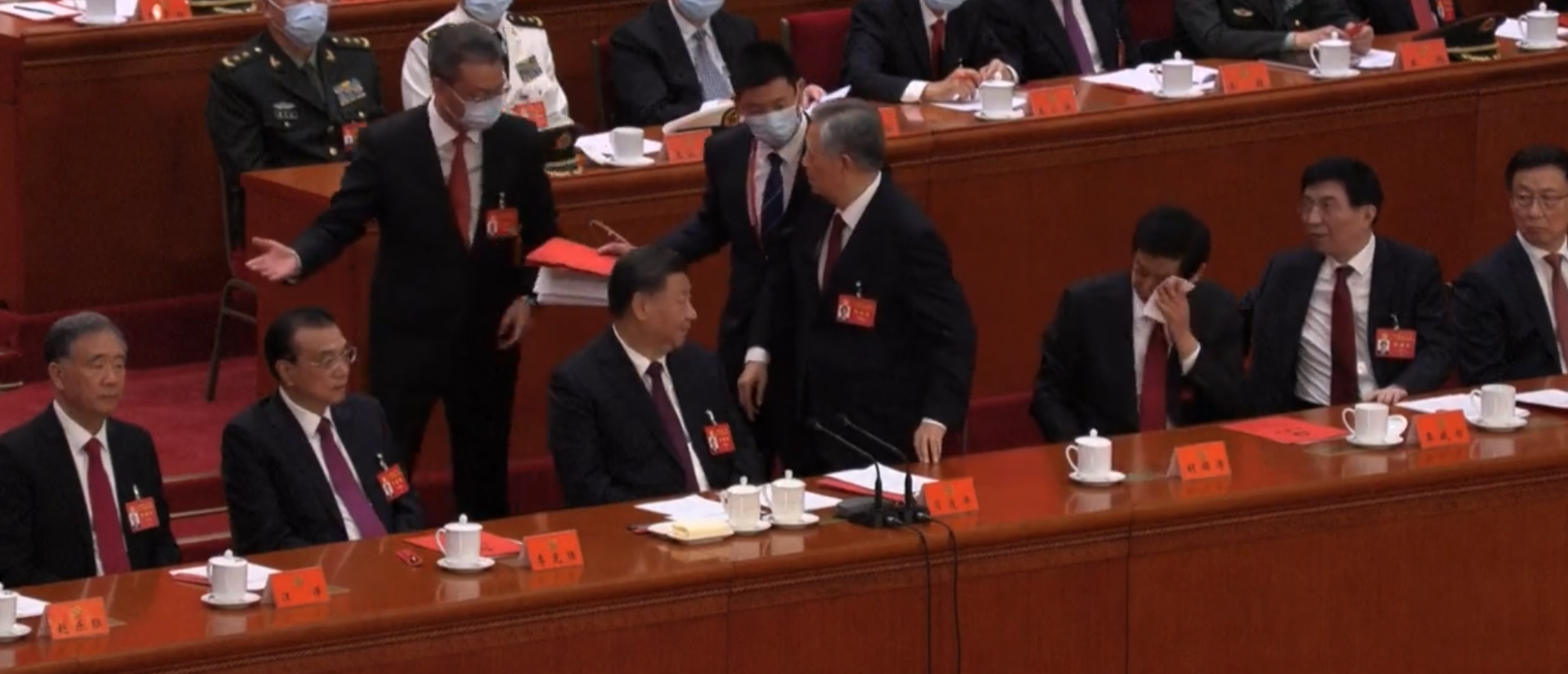 Li Zhanshu wipes sweat from his brow as Hu Jintao is removed from the final session of the 20th National Congress of the Chinese Communist Party on Oct. 22, 2022. (Screenshot/BBCNews)