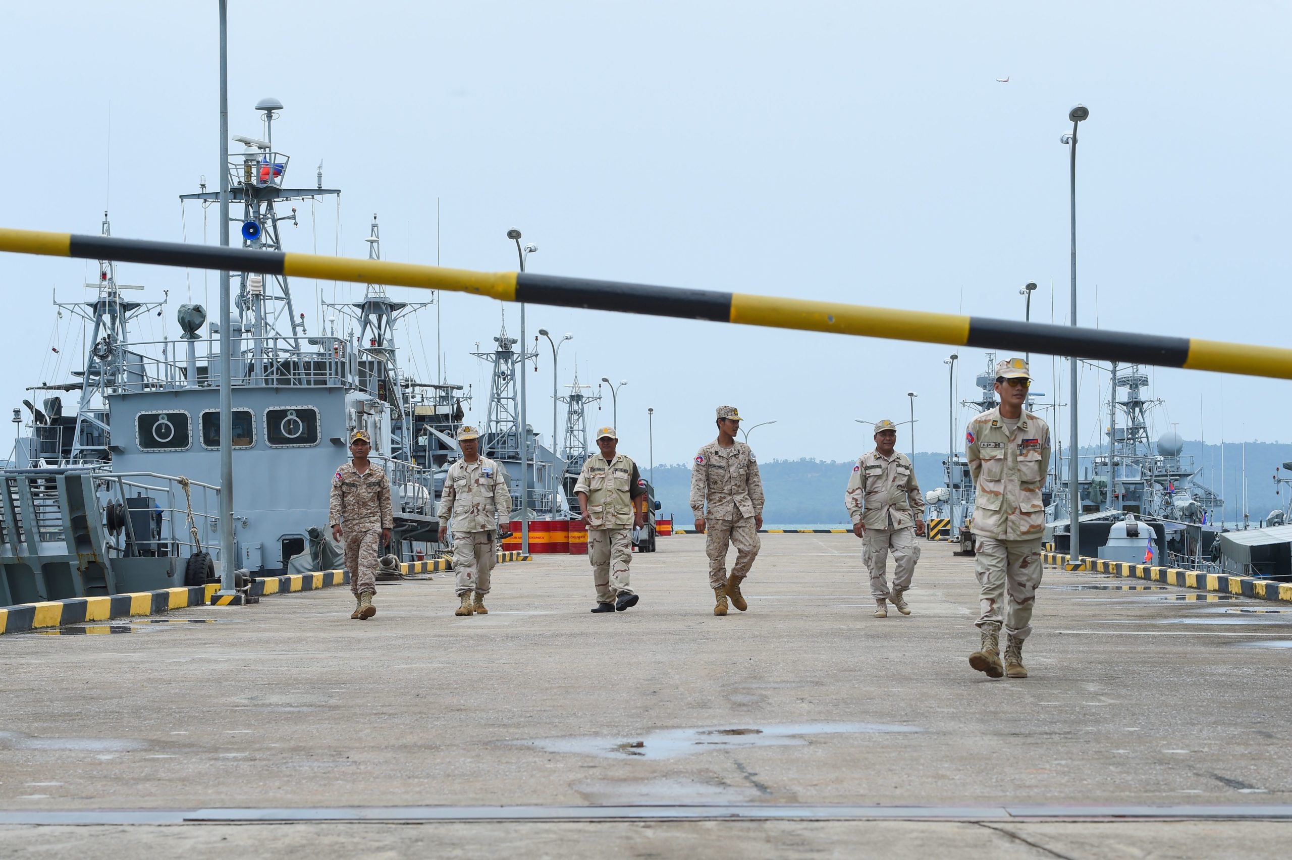 Cambodian navy personnel walk on a jetty in Ream naval base in Preah Sihanouk province during a government organized media tour on July 26, 2019. - Cambodia on July 25 rubbished reports of a deal allowing China to use a naval base as "ill-intended" and aimed at inciting unrest in a country whose public is increasingly uneasy about Beijing's growing influence. 