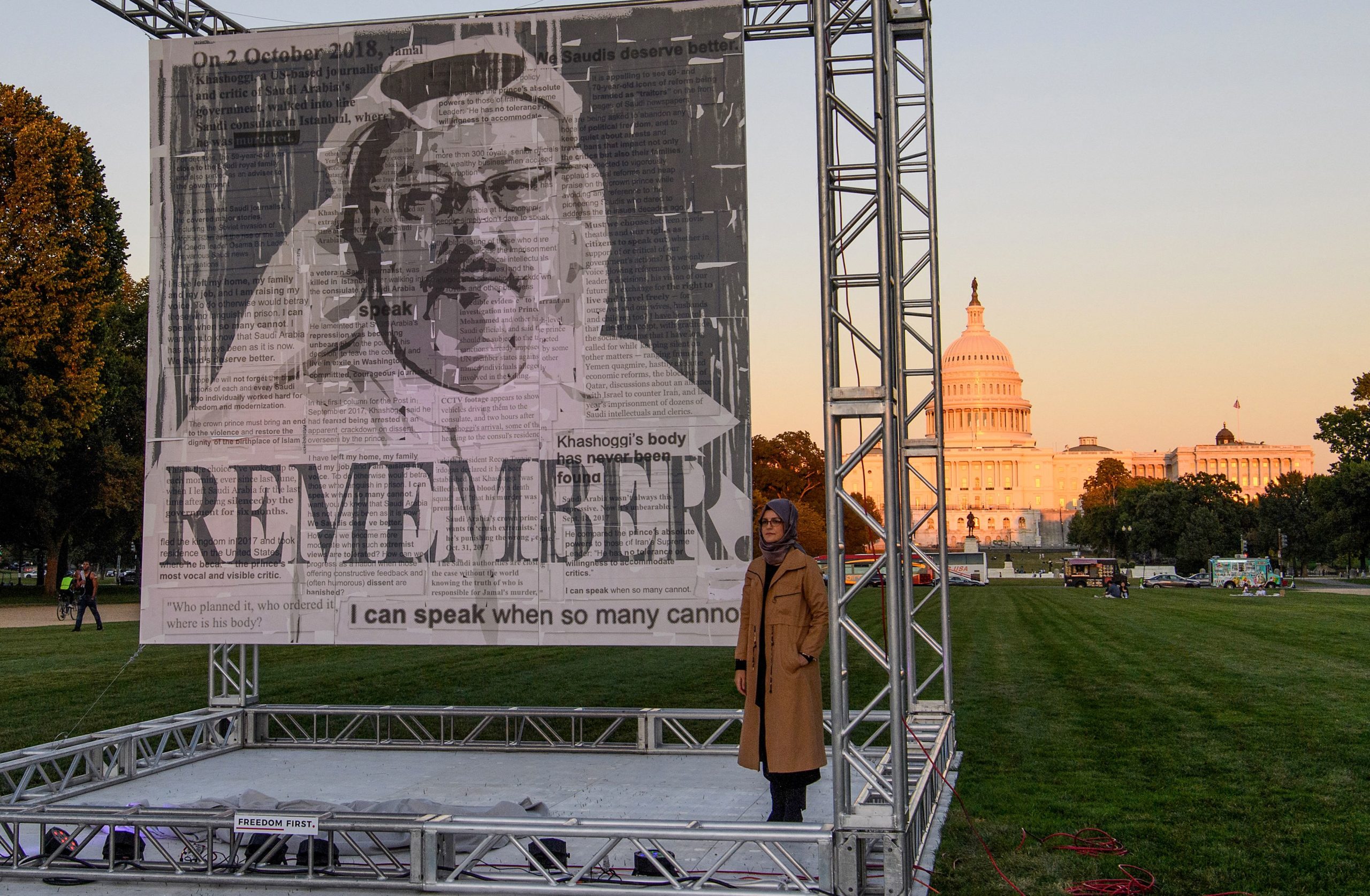 Turkish writer Hatice Cengiz (R), fiancée of Saudi journalist and dissident Jamal Khashoggi, poses next to a portrait of Khashoggi after unveiling it on the National Mall in Washington, DC., on October 1, 2021, during a memorial ceremony marking the third anniversary of his murder at the Saudi consulate in Istanbul.