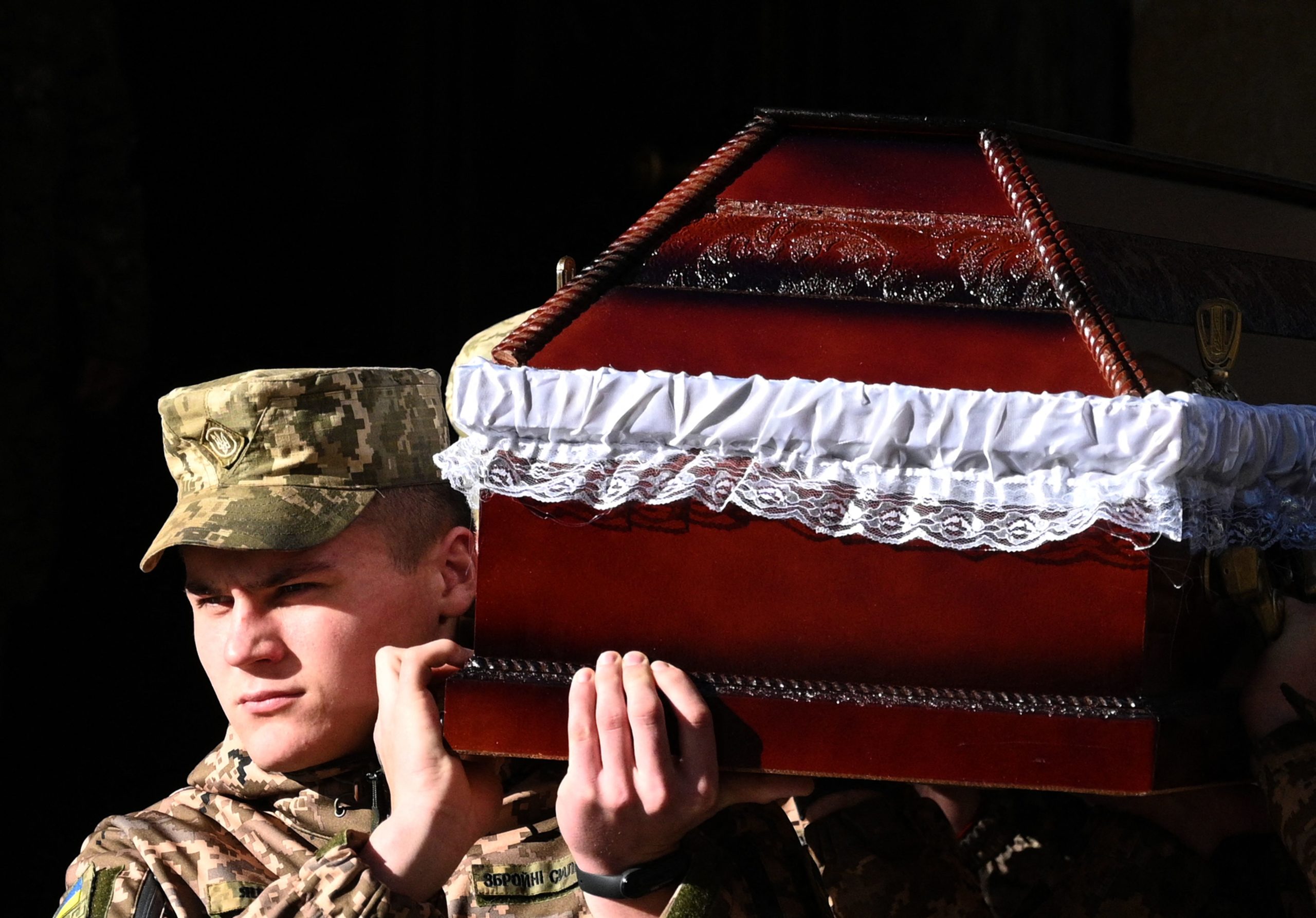 Soldiers carry the coffin of late Ukrainian serviceman Taras-Timofiy Havrylyshyn, member of the Plast Ukrainian scouting organization, during a funeral ceremony in the western Ukrainian city of Lviv, on November 9, 2022, amid the Russian invasion of Ukraine.