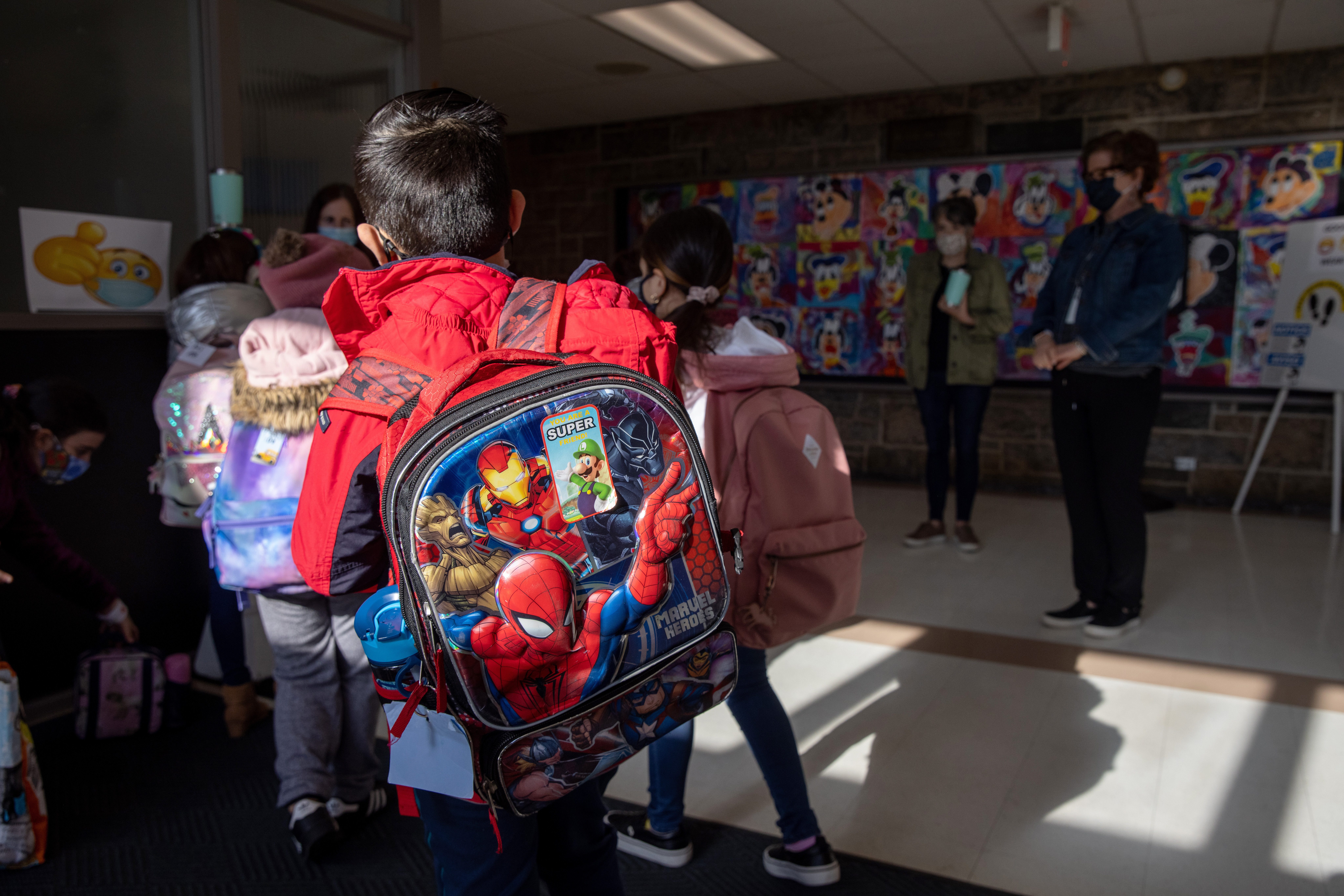Students arrive for the first day of in-person learning for five days per week at Stark Elementary School on March 10, 2021 in Stamford, Connecticut. Stamford Public Schools, like many school districts nationwide, are returning to full time in-school learning as pandemic restrictions begin to ease. The district had been operating on a hybrid model for most of the school year. (Photo by John Moore/Getty Images)