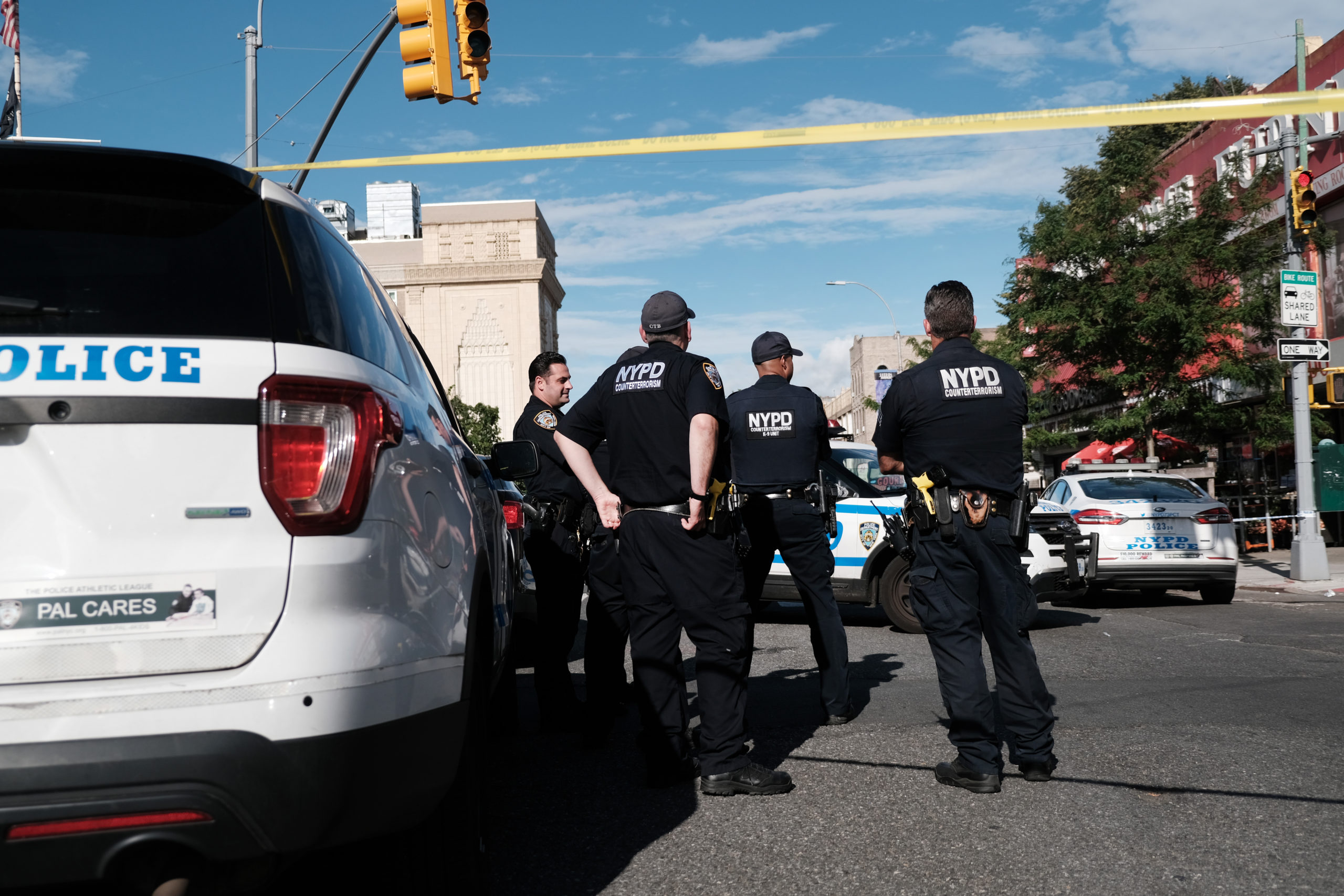 NEW YORK, NEW YORK - JUNE 23: Police gather at the scene of a shooting where an officer was shot in his patrol car in Brooklyn on June 23, 2022 in New York City. The shooting comes on the day that the Supreme Court ruled that New York's laws were too restrictive for individuals wanting a hand gun. (Photo by Spencer Platt/Getty Images)