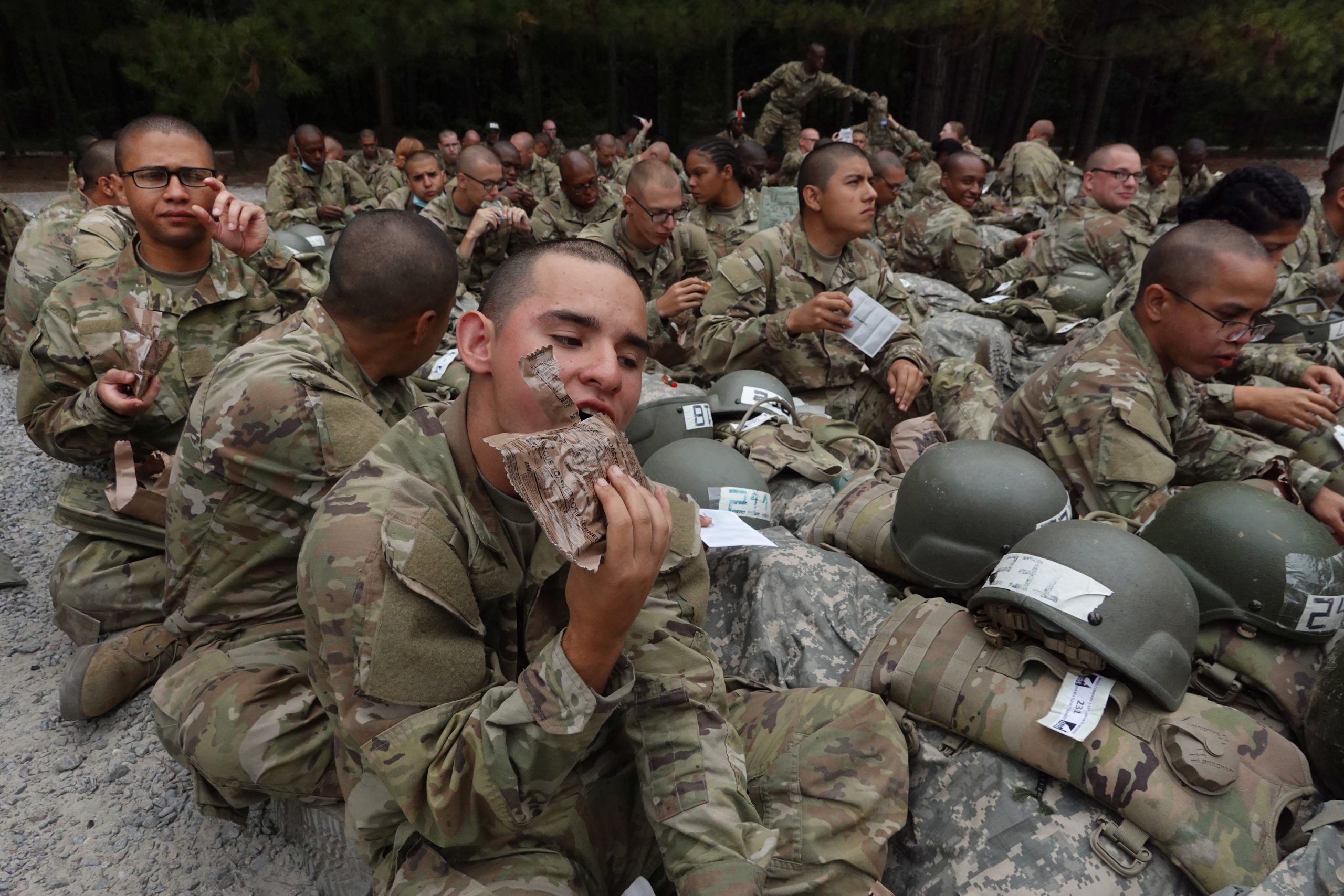 COLUMBIA, SOUTH CAROLINA - SEPTEMBER 29: U.S. Army trainees eat lunch in the field while going through basic training at Fort Jackson on September 29, 2022 in Columbia, South Carolina. Fort Jackson, the largest of the Army's four basic training facilities, trains 60 percent of the Army's new recruits. This past year, the Army has struggled to meet its recruiting goals, falling short by about 15,000 recruits or about 25 percent of its goal as it closed the fiscal year. 