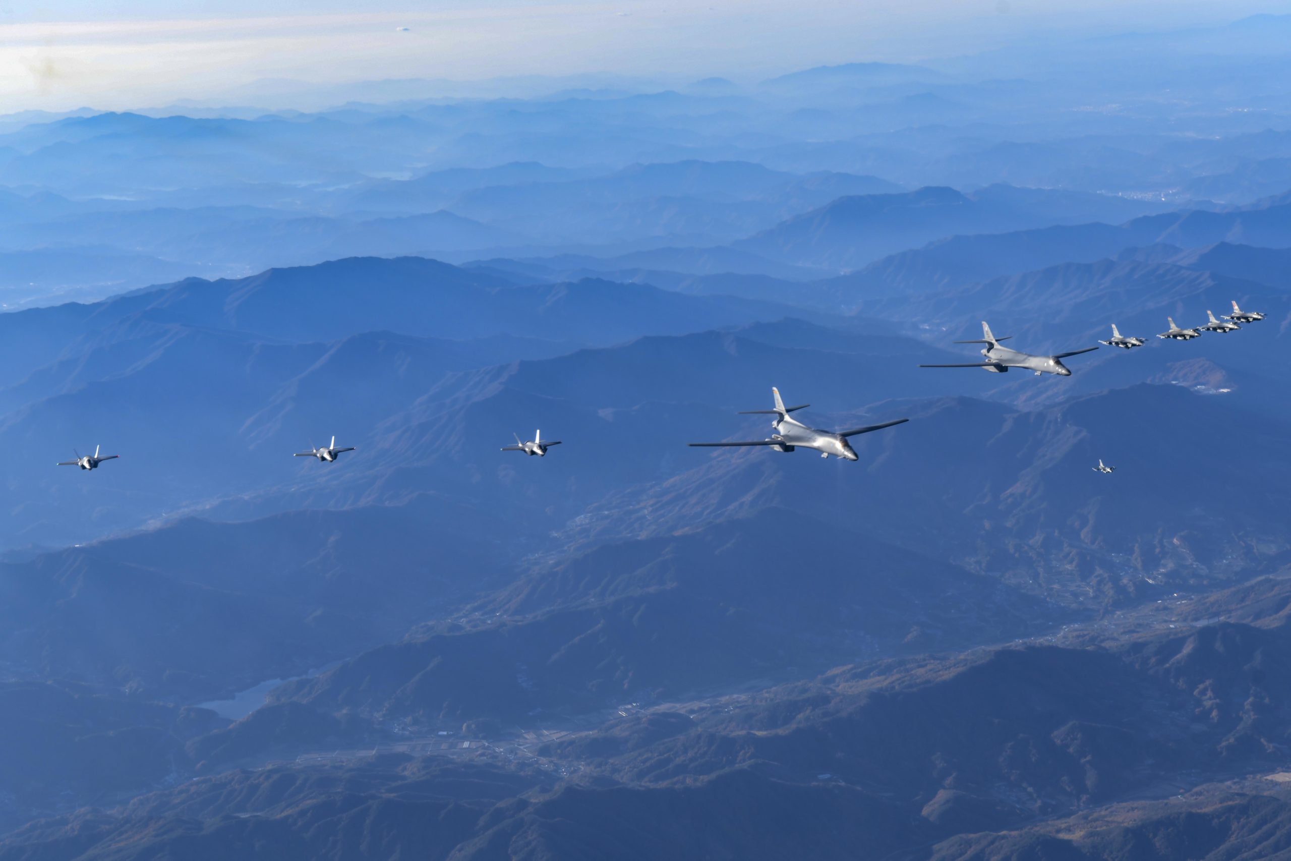 UNDISCLOSED LOCATION, SOUTH KOREA - NOVEMBER 05: In this handout image released by the South Korean Defense Ministry, two U.S. B-1B Lancer strategic bombers, four South Korean Air Force F-35 fighter jets and four U.S. Air Force F-16 fighter jets fly over South Korea during the "Vigilant Storm" joint air drill on November 05, 2022 at an undisclosed location in South Korea. After flying from Guam, the planes made a sortie over the peninsula as part of the extended "Vigilant Storm" practice. North Korea fired four short-range ballistic missiles (SRBM) toward the Yellow Sea on Saturday, the South Korean military said. The North's latest provocation came on the last day of the extended large-scale combined air drills by the South and the United States.