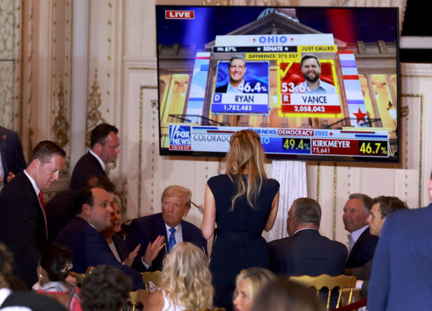 PALM BEACH, FLORIDA - NOVEMBER 08: Former U.S. President Donald Trump sits with supporters as election returns are shown on a TV screen during an election night event at Mar-a-Lago on November 08, 2022 in Palm Beach, Florida. Trump mingled with supporters as the nation awaits the results of voting in the midterm elections. (Photo by Joe Raedle/Getty Images)