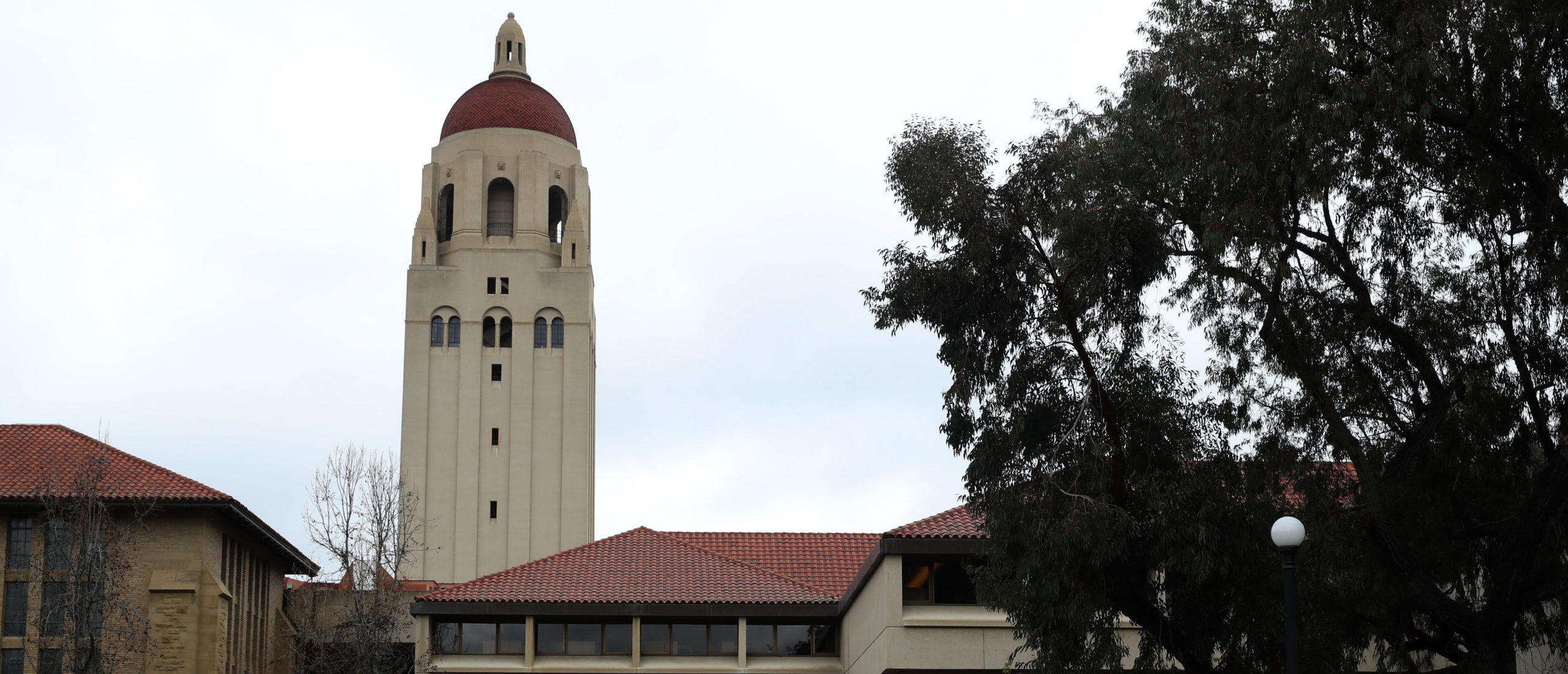 STANFORD, CALIFORNIA - MARCH 12: People walk by Hoover Tower on the Stanford University campus on March 12, 2019 in Stanford, California. More than 40 people, including actresses Lori Loughlin and Felicity Huffman, have been charged in a widespread elite college admission bribery scheme. Parents, ACT and SAT administrators and coaches at universities including Stanford, Georgetown, Yale, and the University of Southern California have been charged. (Photo by Justin Sullivan/Getty Images)