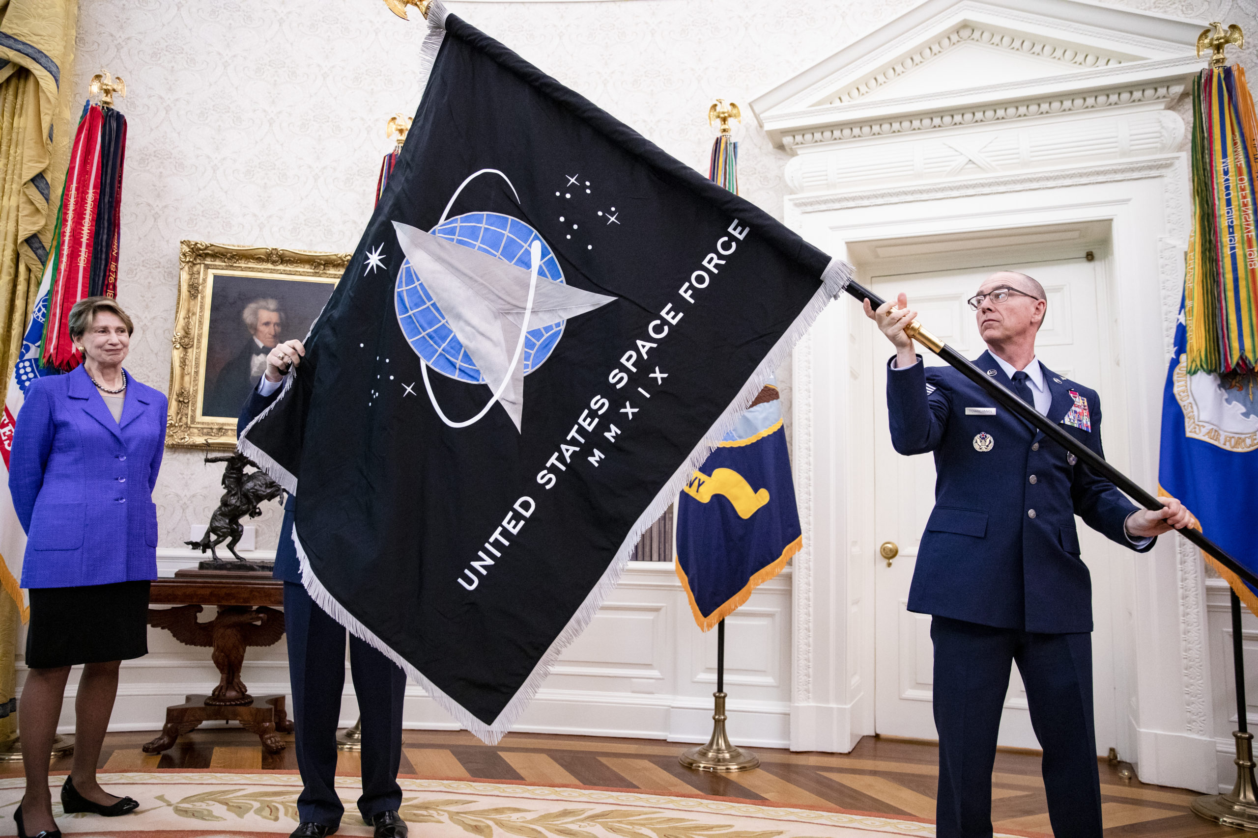 WASHINGTON, DC - MAY 15: Chief Master Sgt. Roger Towberman (R), Space Force and Command Senior Enlisted Leader and CMSgt Roger Towberman (L), with Secretary of the Air Force Barbara Barrett present US President Donald Trump with the official flag of the United States Space Force in the Oval Office of the White House in Washington, DC on May 15, 2020. 
