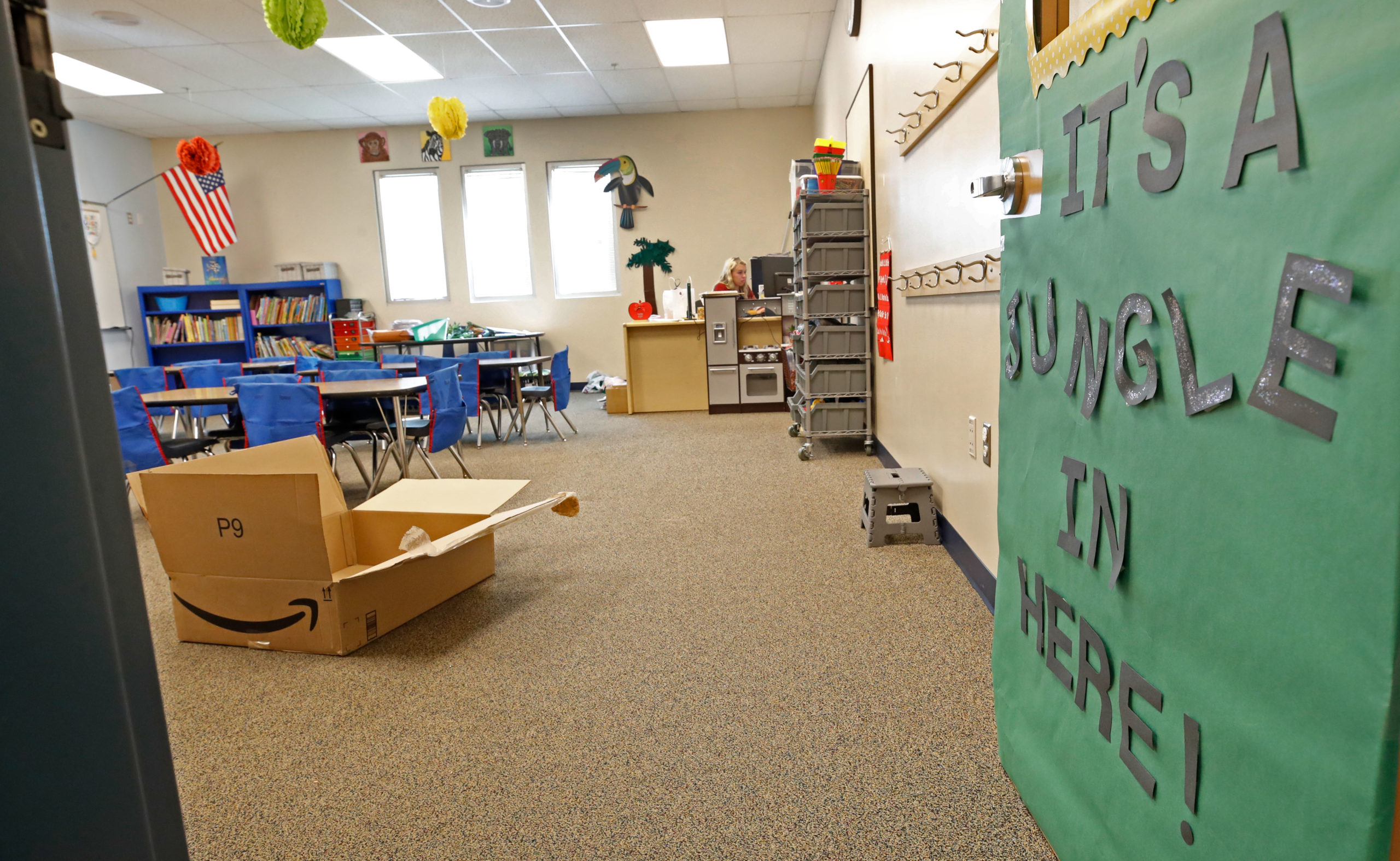 A teacher sets up her classroom at Freedom Preparatory Academy as they begin to prepare to restart school after it was closed in March due to COVID-19 on August 13, 2020 in Provo, Utah. The school is planning to have students return on August 18 for five days a week instruction, but with reduced hours during the day. (Photo by George Frey/Getty Images)