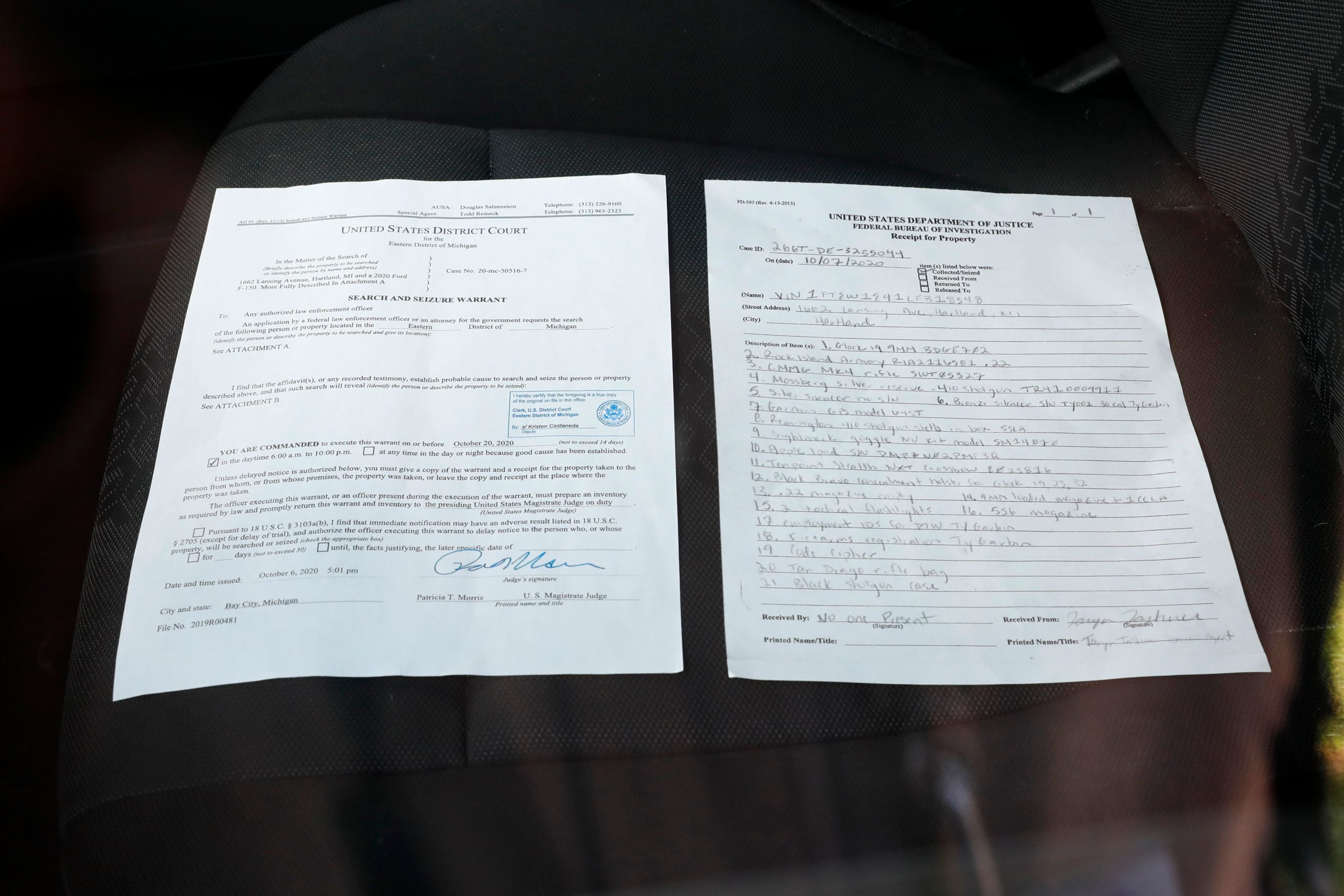 A copy of a search warrant and property list is left on a car seat after FBI searched a home in a Hartland Township mobile home park late Wednesday night and into the morning in connection with a plot to kidnap Michigan Governor Gretchen Whitmer, on October 8, 2020 in Heartland, Michigan. - Six men have been charged as part of a militia plot to kidnap Michigan Governor Gretchen Whitmer, who was repeatedly attacked by President Donald Trump this year for her tough coronavirus lockdown, according to court records released. (Photo by JEFF KOWALSKY / AFP) (Photo by JEFF KOWALSKY/AFP via Getty Images)