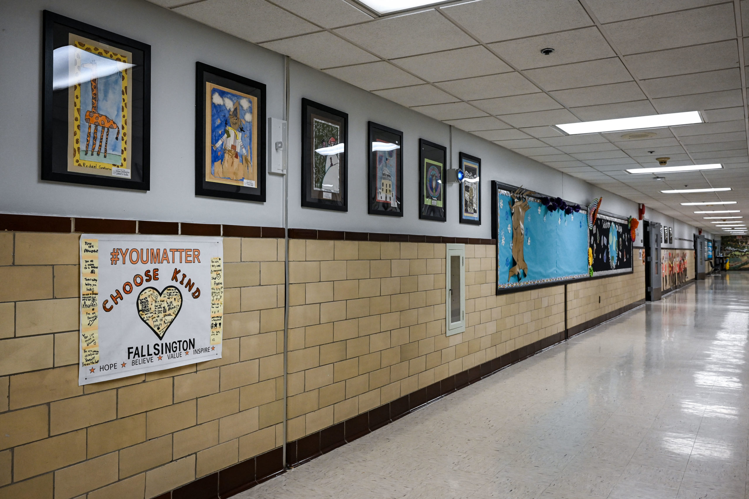 View of the corridor at Fallsington Elementary School in Levittown, Pennsylvania on December 16, 2021. - As Joshua Waldorf was running for a third term on the Pennsbury school board in November, one particularly heated debate triggered a flood of vitriolic messages to his inbox -- one of them urging him to shoot himself. In a shift mirrored in cities across America, his local council overseeing schools in the leafy suburbs of Philadelphia had unwittingly become a battleground in the politicized culture wars roiling the nation. The hateful messages aimed at Waldorf were just one example of the flow of anonymous slurs and threats directed at him and fellow members of the nine-seat board in past months -- as their once studious meetings turned to angry shouting matches. (Photo by Kylie COOPER / AFP) (Photo by KYLIE COOPER/AFP via Getty Images)
