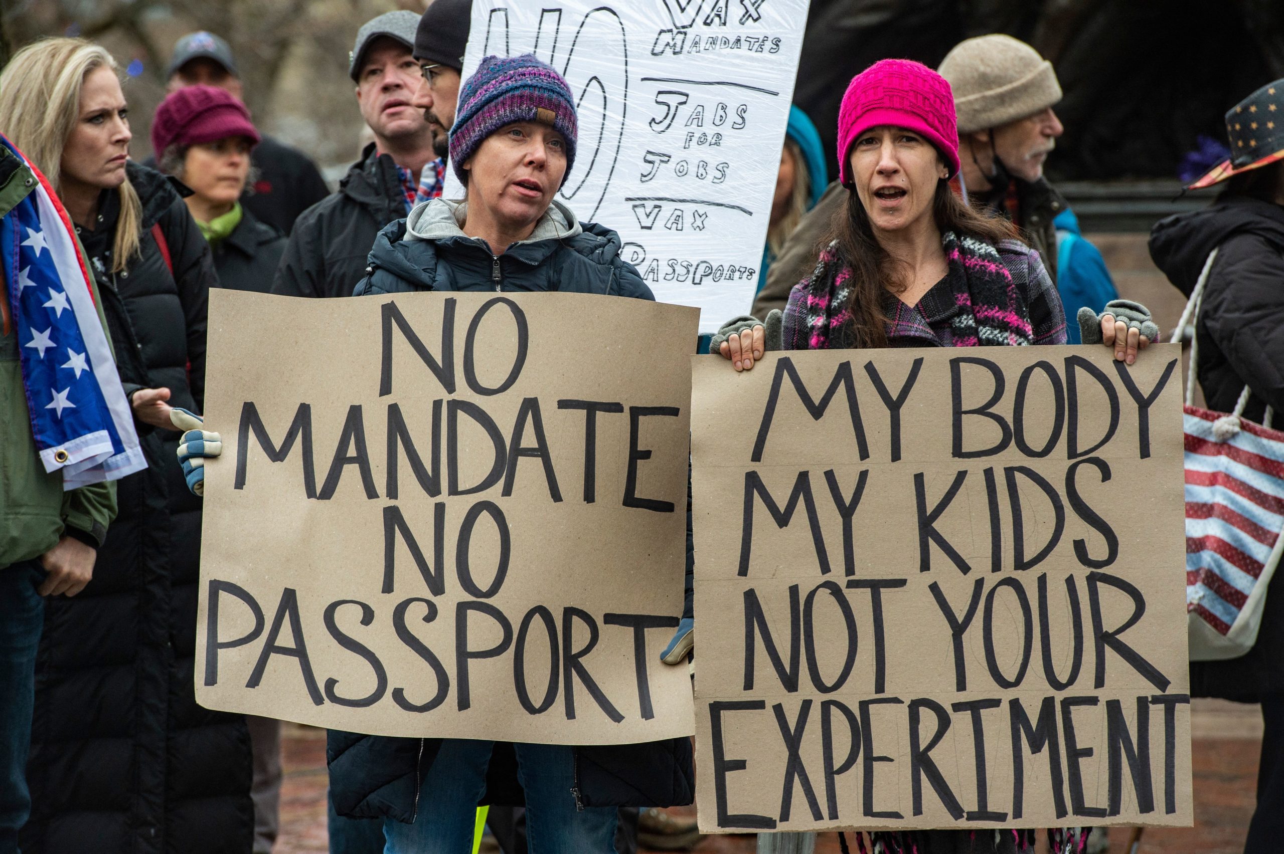 Demonstrators protest masks, vaccine mandates and vaccine passports, with some supporting vaccines, at the State House in Boston, Massachusetts on January 5, 2022.