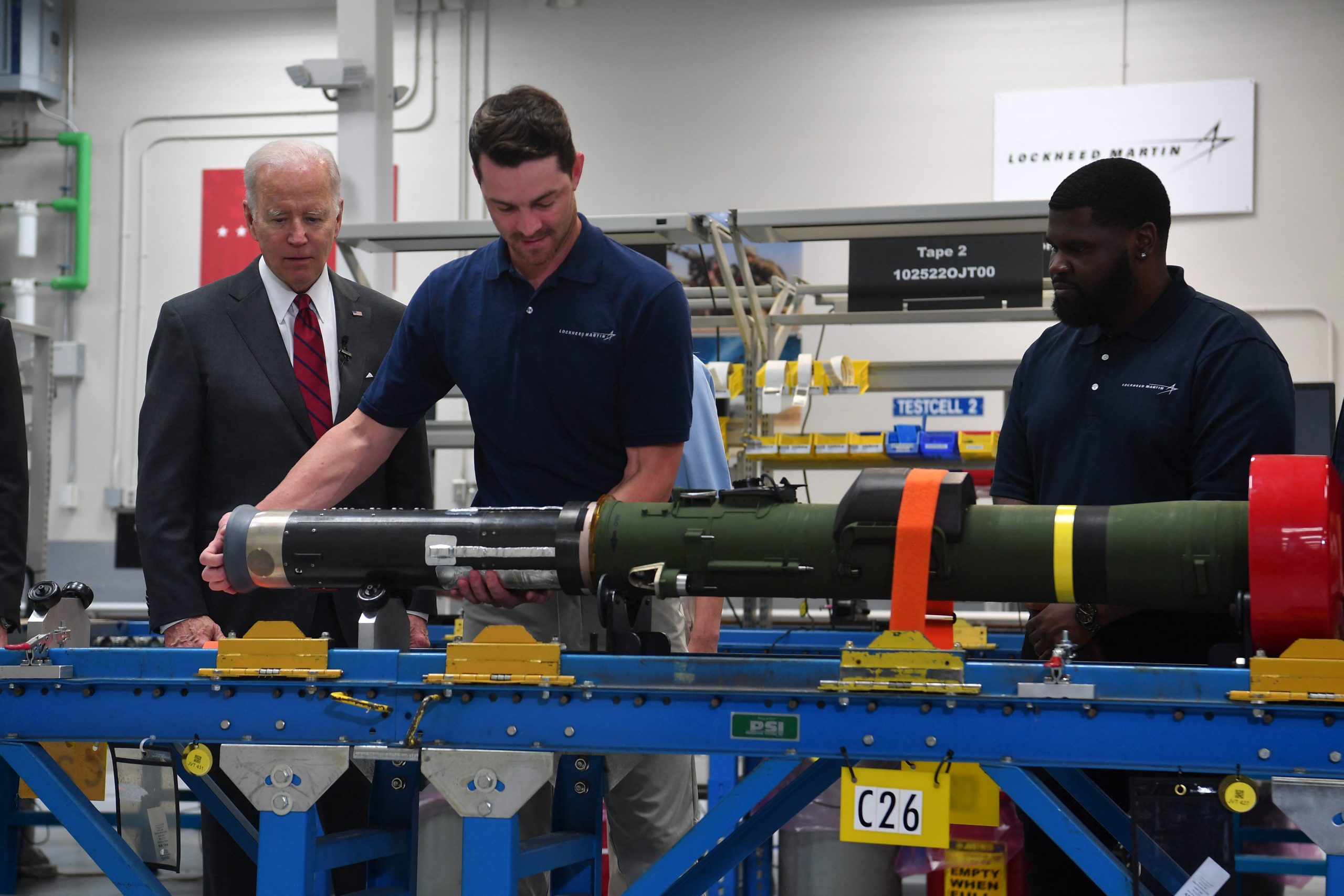 US President Joe Biden watches employees as he tours the Lockheed Martins Pike County Operations facility in Troy, Alabama, on May 3, 2022. - Biden is traveling to Troy, Alabama, to visit a Lockheed Martin Martin facility which manufactures weapon systems. 
