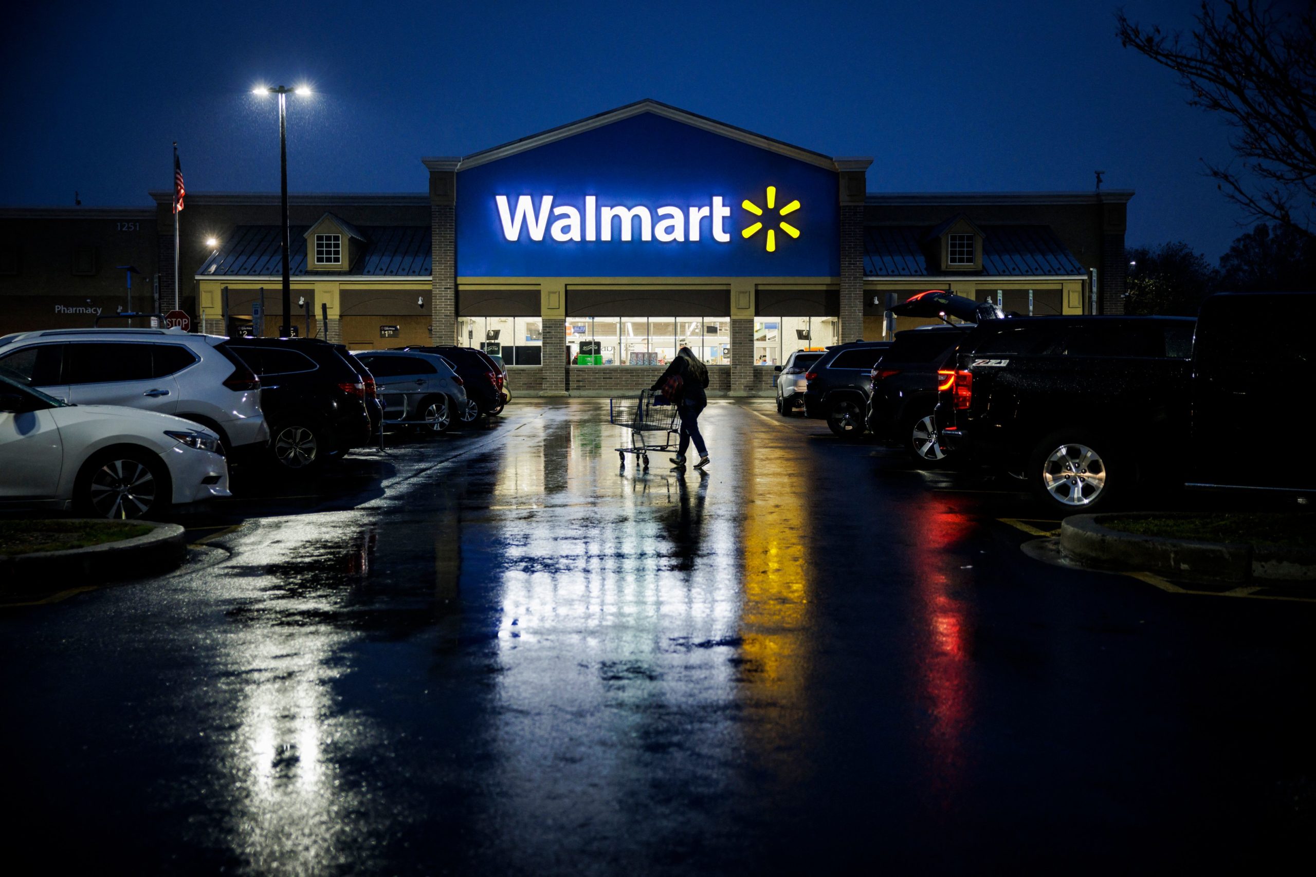 A shopper pushes a cart through the parking lot of a Walmart on the morning of Black Friday in Wilmington, Delaware, on November 25, 2022. - With inflation on the rise, retailers are expecting that many shoppers will be looking for especially good deals as discretionary spending falls. (Photo by Samuel Corum / AFP) (Photo by SAMUEL CORUM/AFP via Getty Images)