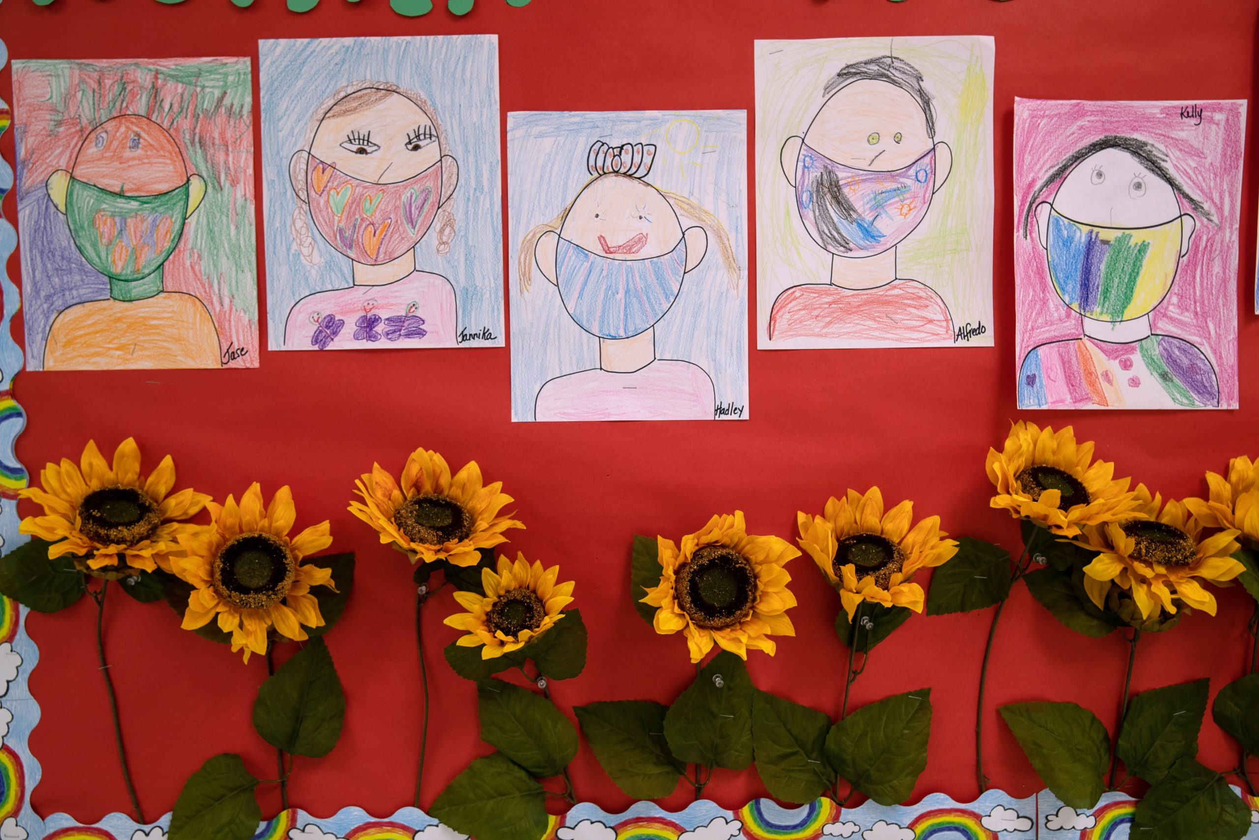 Drawings of children wearing masks adorn a hallway at Stark Elementary School on September 16, 2020 in Stamford, Connecticut. Most students at Stamford Public Schools are taking part in a hybrid education model, where they attend in-school classes every other day and distance learn the rest. About 20 percent of students in the school district, however, are enrolled in the distance learning option due to coronavirus concerns. (Photo by John Moore/Getty Images)