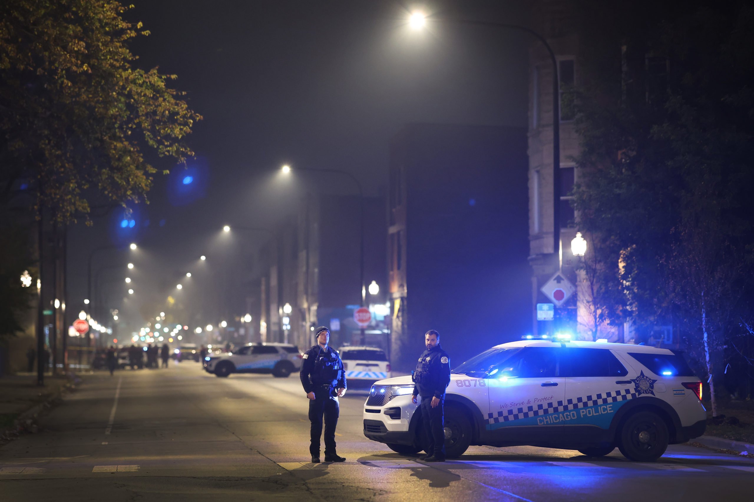 CHICAGO, ILLINOIS - OCTOBER 31: Police investigate the scene where as many as 14 people were reported to have been shot on October 31, 2022 in Chicago, Illinois. Three juveniles were among those reported to have been wounded in the drive-by shooting, according to published reports. (Photo by Scott Olson/Getty Images)