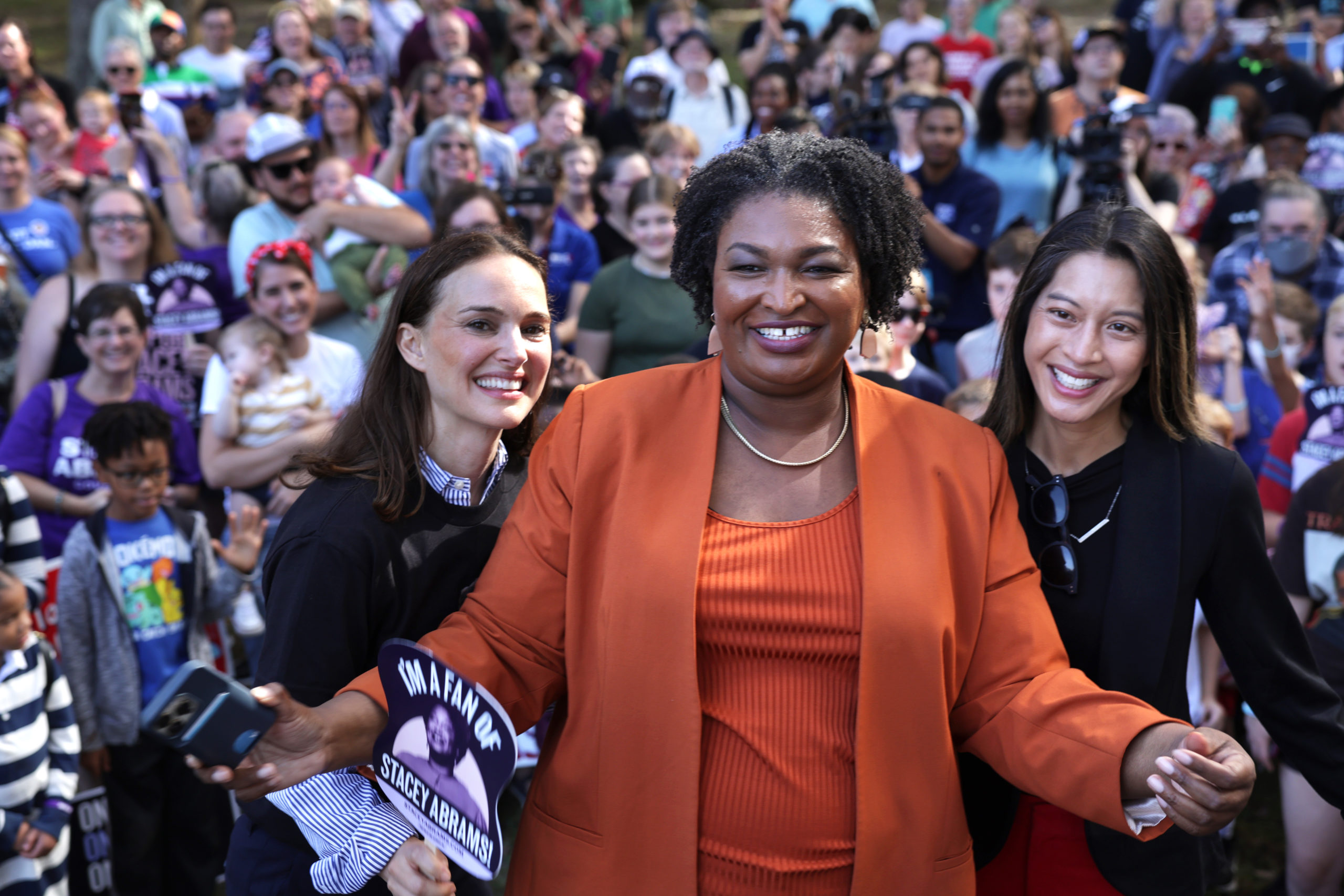SAVANNAH, GEORGIA - NOVEMBER 05: Democratic Georgia gubernatorial candidate Stacey Abrams (C) poses for photos with supporters, actress Natalie Portman (L) and Democratic candidate for Georgia Secretary of State, and Georgia State House Rep. Bee Nguyen (D-89th District) (R) during a stop of her statewide campaign bus tour on November 5, 2022 in Savannah, Georgia. (Photo by Alex Wong/Getty Images)