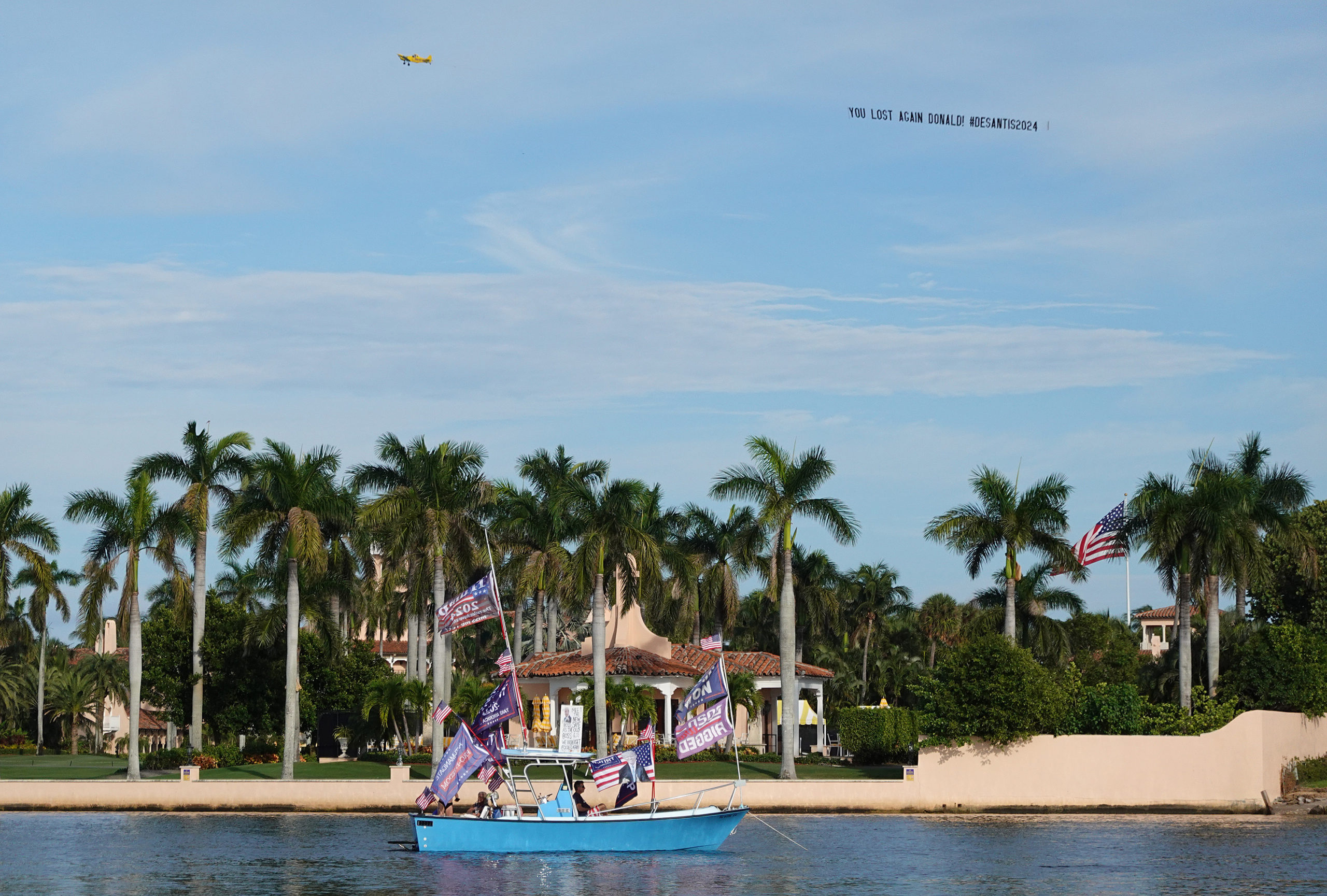 PALM BEACH, FLORIDA - NOVEMBER 15: A plane pulls a banner reading, 'You Lost Again Donald! #DESANTIS2024,' past the Mar-a-Lago home of former U.S. President Donald Trump before he speaks this evening on November 15, 2022 in Palm Beach, Florida. Trump is expected to announce his 2024 campaign for U.S. president. (Photo by Joe Raedle/Getty Images)