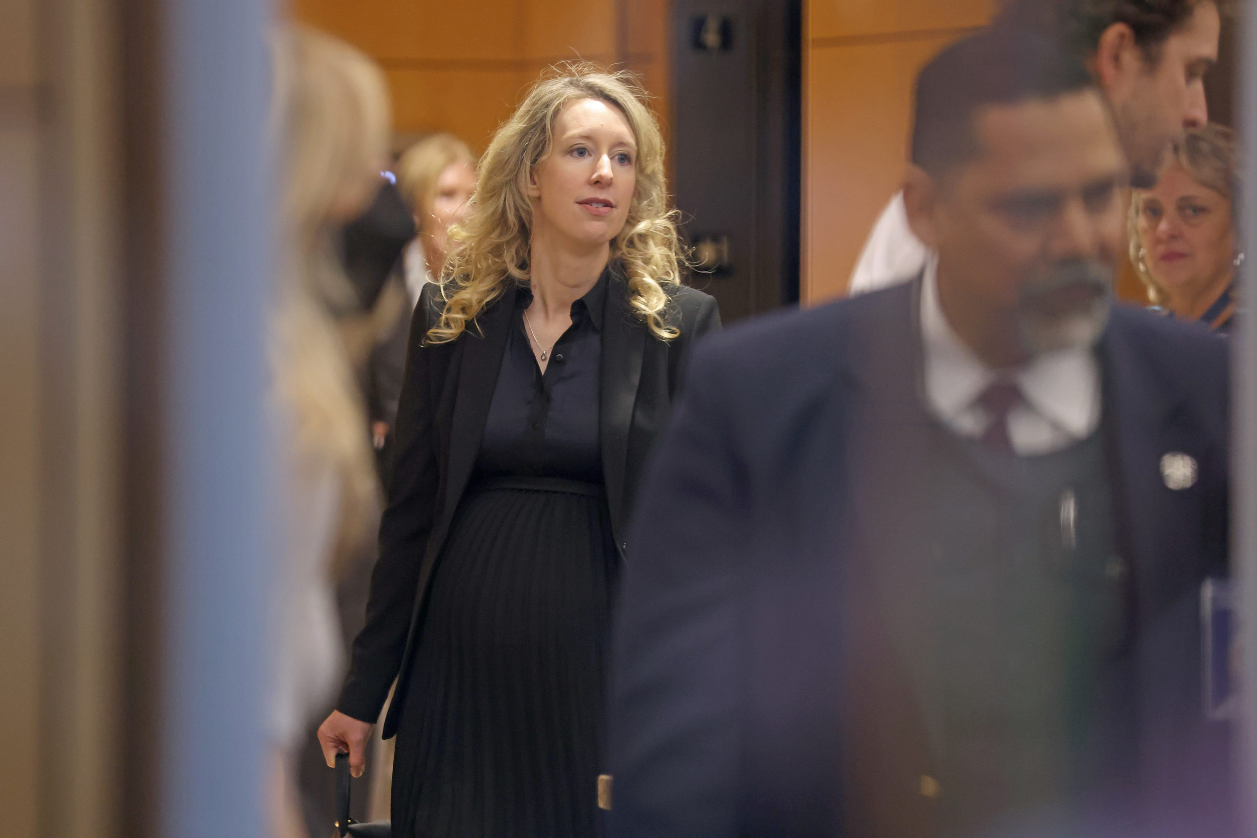 SAN JOSE, CALIFORNIA - NOVEMBER 18: Former Theranos CEO Elizabeth Holmes goes through a security checkpoint as she arrives at federal court on November 18, 2022 in San Jose, California. Holmes appeared in federal court for sentencing after being convicted of four counts of fraud for allegedly engaging in a multimillion-dollar scheme to defraud investors in her company Theranos, which offered blood testing lab services. (Photo by Justin Sullivan/Getty Images)