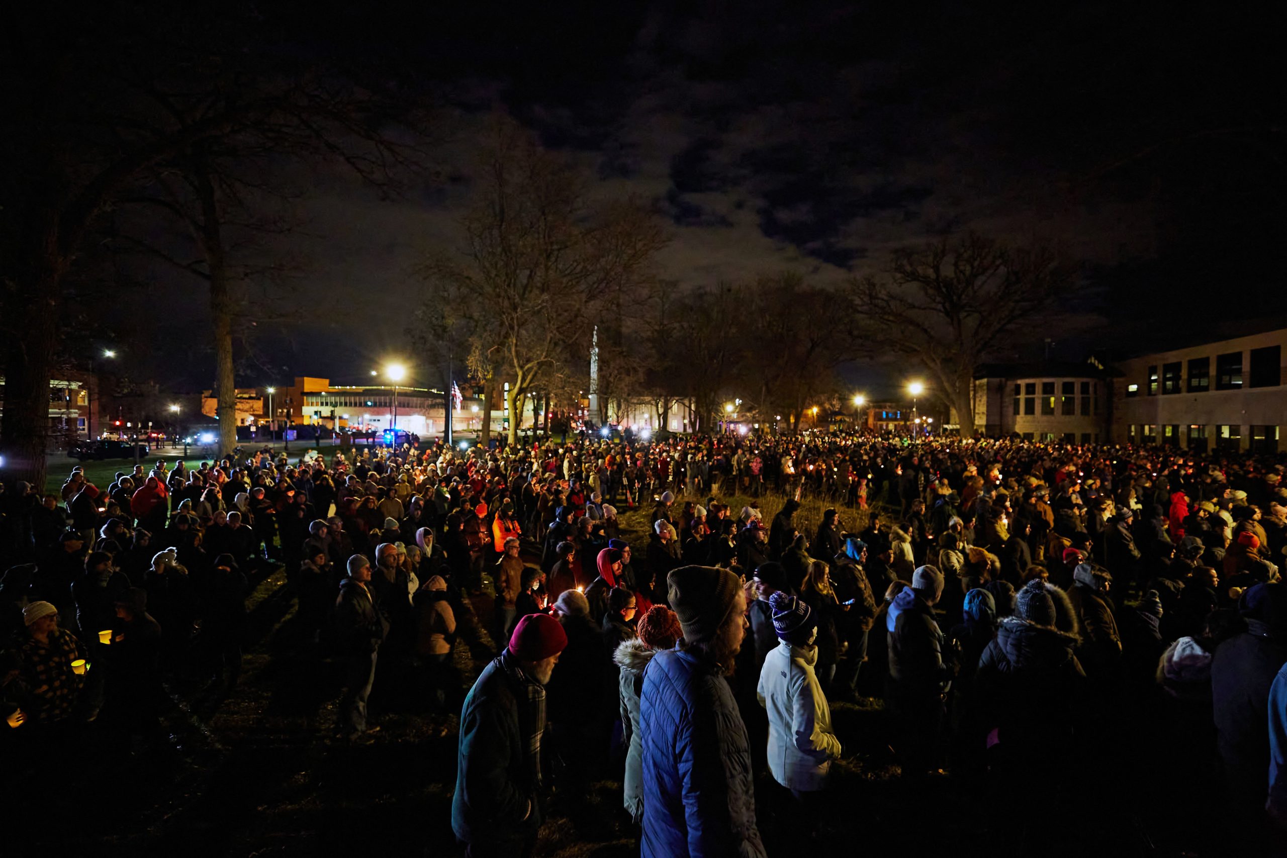 TOPSHOT - People attend a candle light vigil in Cutler Park in Waukesha, Wisconsin on November 22, 2021, the day after a vehicle drove through a Christmas parade killing five people. - US authorities identified the driver suspected of plowing into a Christmas parade in the Midwestern city of Waukesha, killing at least five and wounding dozens, as media reported he was fleeing a knife fight. The Sunday evening chaos in Wisconsin, which saw a red SUV speed into a crowd of men, women and children raised immediate fears of a deliberate act -- in a state where tensions have spiked following a high-profile acquittal in a racially-charged trial. (Photo by Mustafa Hussain / AFP) (Photo by MUSTAFA HUSSAIN/AFP via Getty Images)