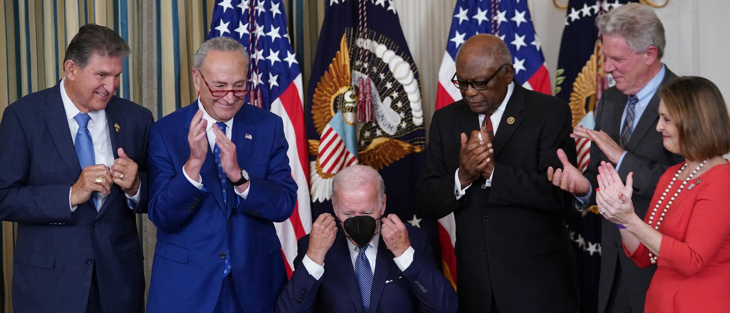 US President Joe Biden puts on his mask after signing H.R. 5376, the Inflation Reduction Act of 2022, in the State Dining Room of the White House in Washington, DC on August 16, 2022. (Photo by MANDEL NGAN/AFP via Getty Images)