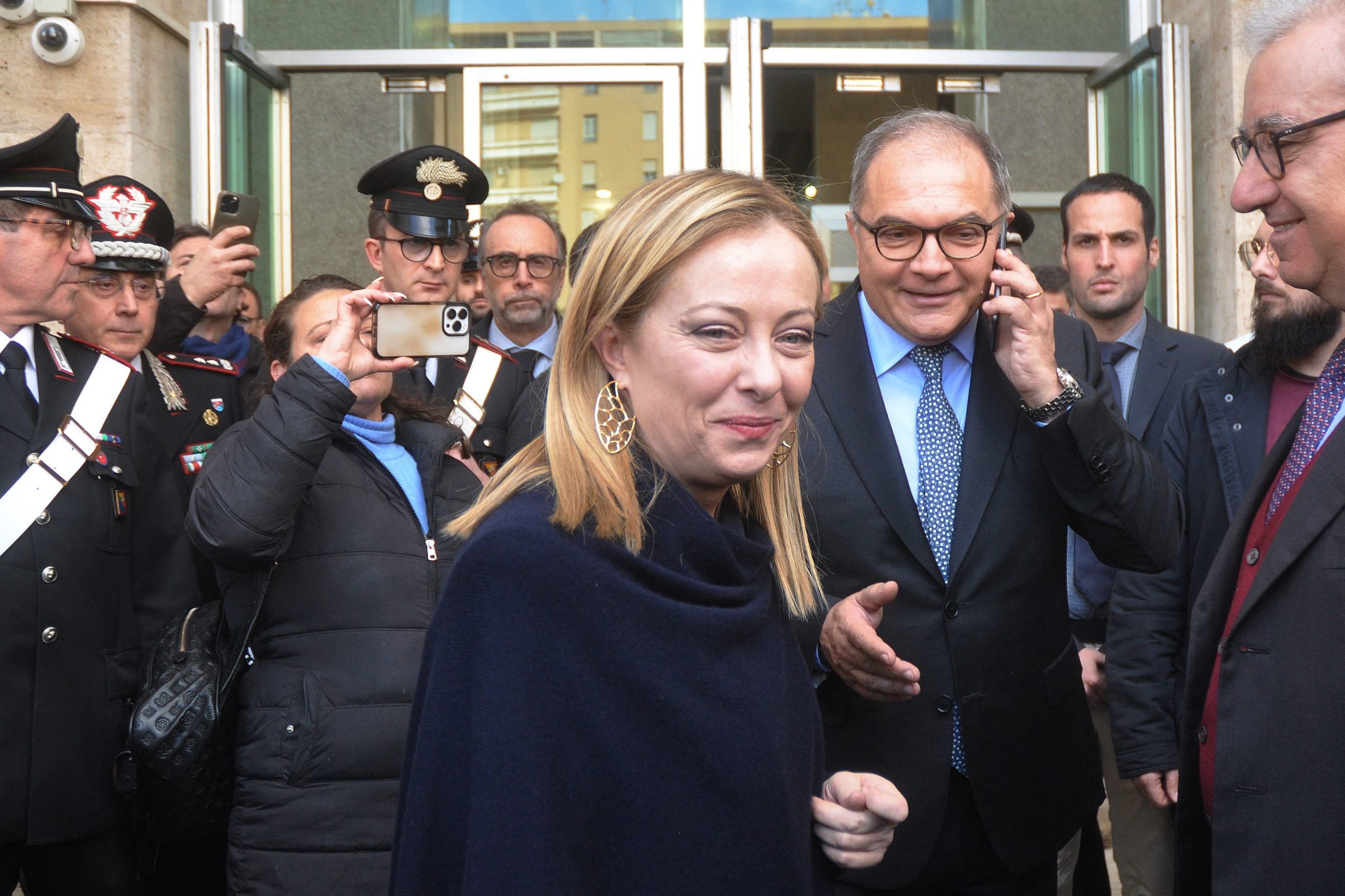 Italy's Prime minister Giorgia Meloni (C) and Palermo prosecutor Maurizio De Lucia (2nd R) arrive in Palermo to meet police officers after the arrest of the Italy's top wanted mafia boss, Matteo Messina Denaro in Palermo, on January 16, 2023. - Italian anti-mafia police caught Sicilian godfather Matteo Messina Denaro on January 16, 2023, ending a 30-year manhunt for Italy's most wanted fugitive. The mobster was nabbed "inside a health facility in Palermo, where he had gone for therapeutic treatment", special operations commander Pasquale Angelosanto said in a statement released by the police. (Photo by Alessandro FUCARINI / AFP) (Photo by ALESSANDRO FUCARINI/AFP via Getty Images)