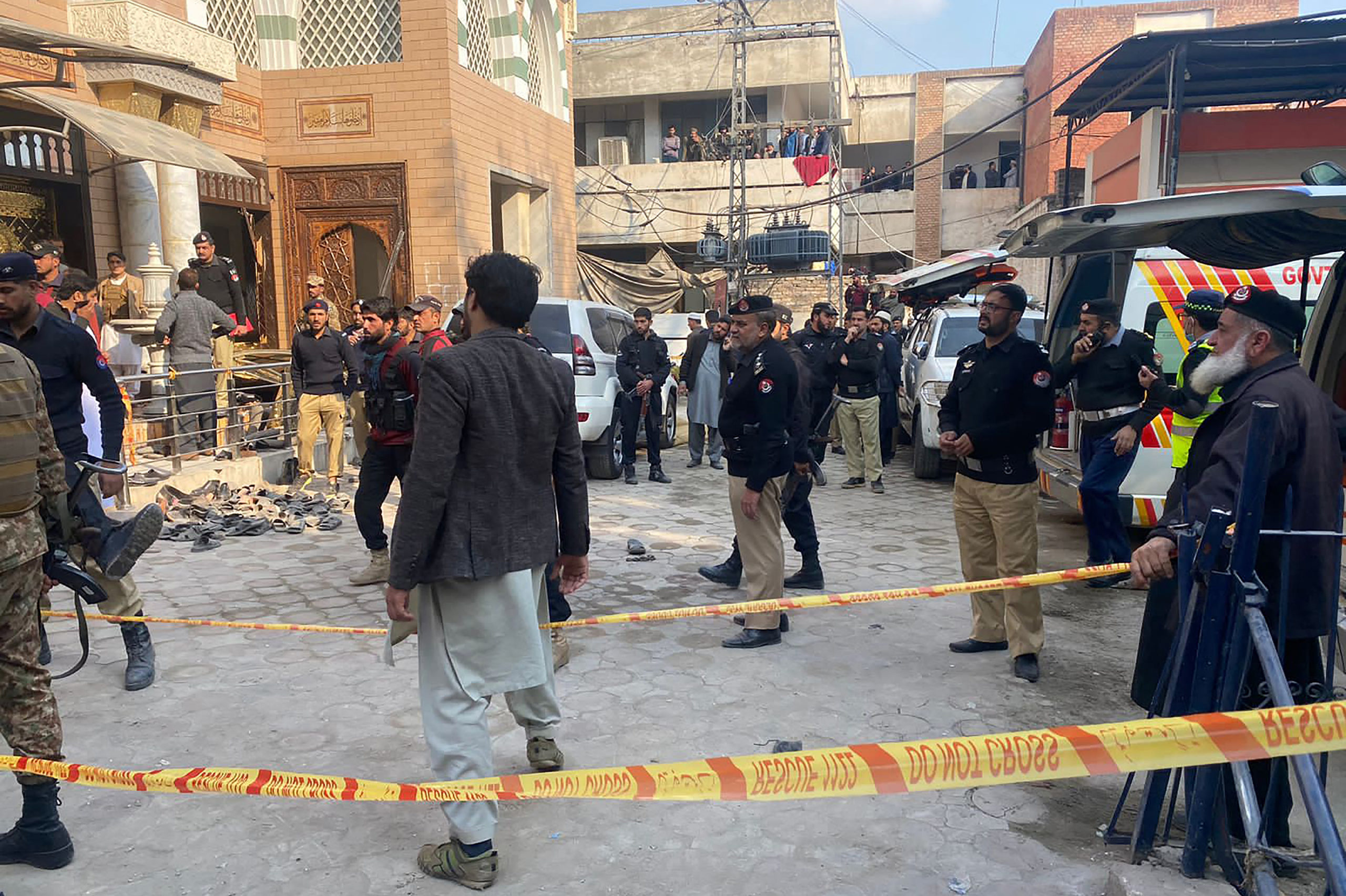 Security personnel cordon off the site of a mosque blast inside the police headquarters in Peshawar on January 30, 2023. - At least 25 people were killed and 120 were injured in a mosque blast at a police headquarters in Pakistan on January 30, a local government official said. (Photo by Maaz ALI / AFP) (Photo by MAAZ ALI/AFP via Getty Images)