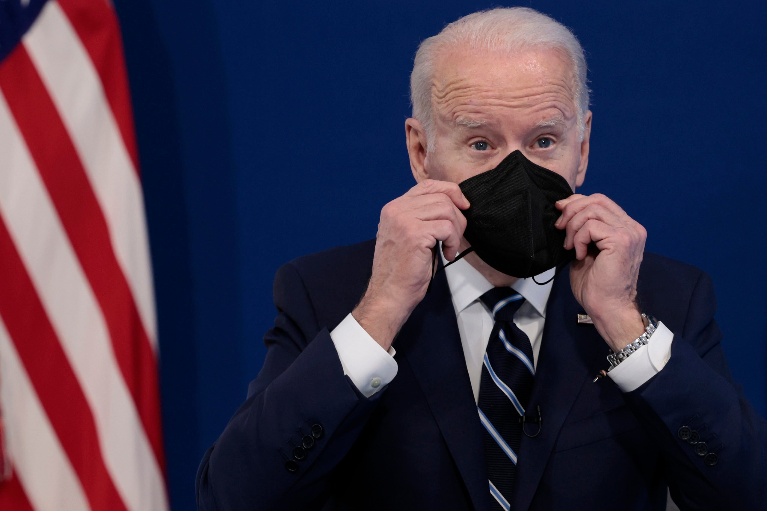 WASHINGTON, DC - JANUARY 13: U.S. President Joe Biden holds a mask as he gives remarks on his administration's response to the surge in COVID-19 cases across the country from the South Court Auditorium in the Eisenhower Executive Office Building on January 13, 2022 in Washington, DC. Photo by Anna Moneymaker/Getty Images