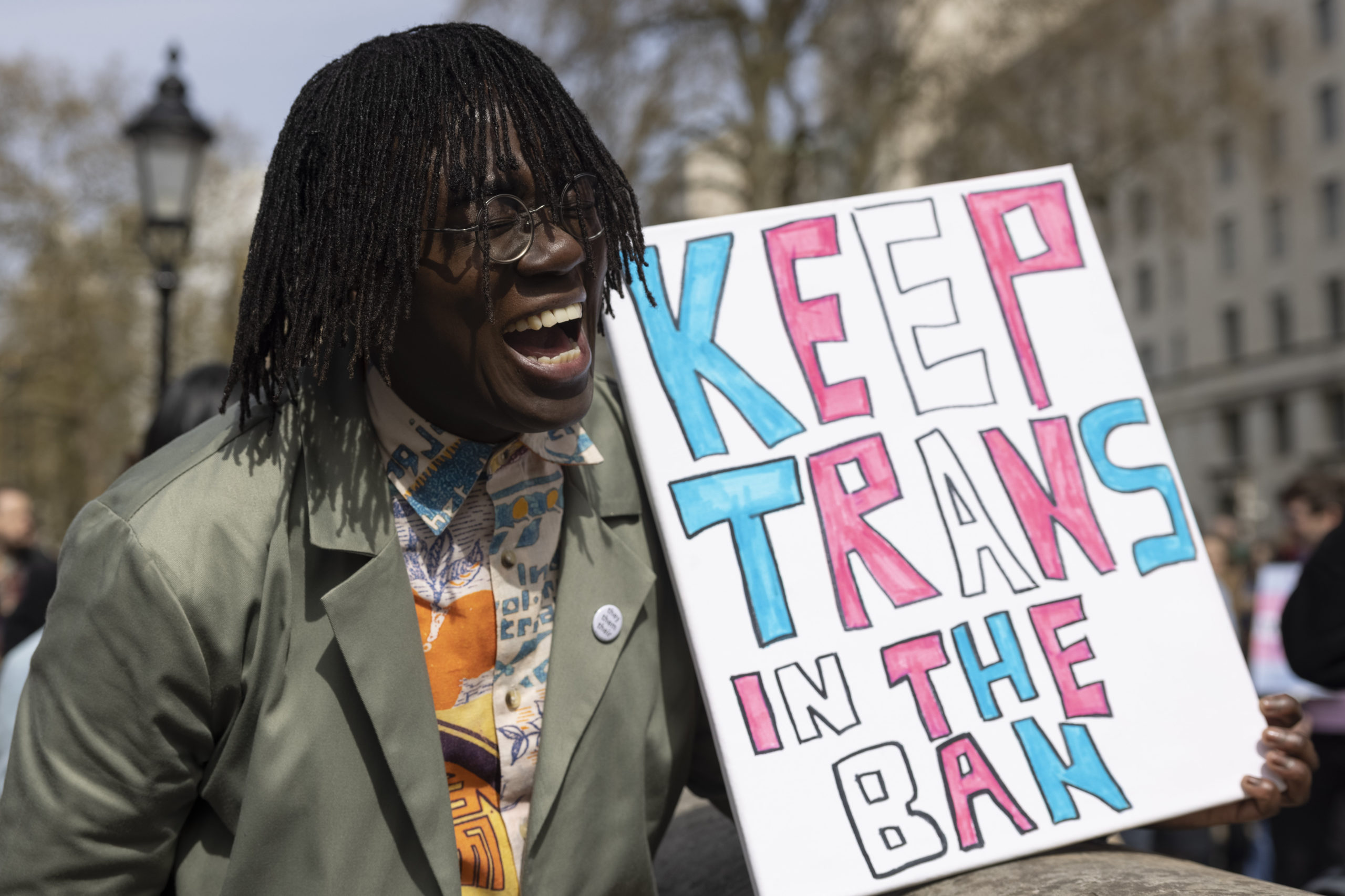 LONDON, ENGLAND - APRIL 10: A demonstrator holds a placard during the No Ban Without Trans protest opposite Downing Street on April 10, 2022 in London, England. (Photo by Hollie Adams/Getty Images)