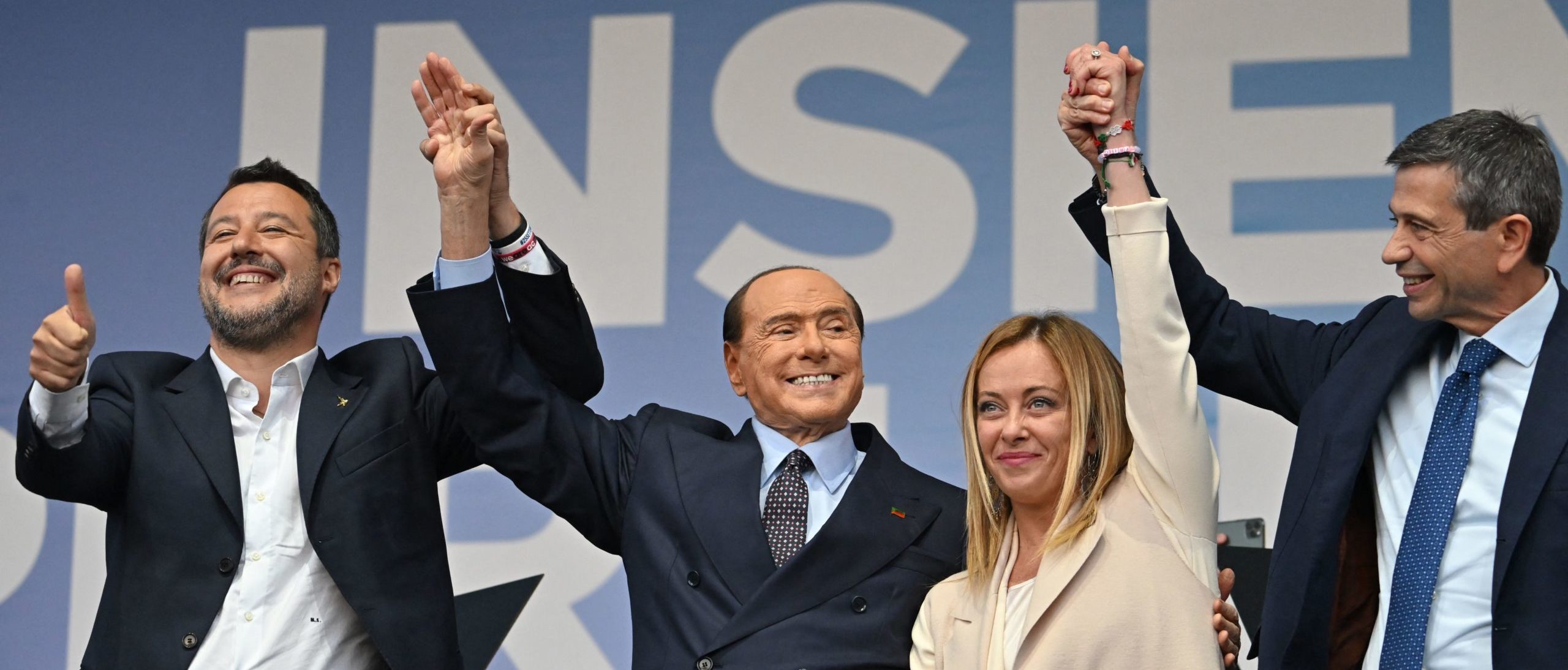 TOPSHOT - (From L) Leader of Italian far-right Lega (League) party Matteo Salvini, Forza Italia leader Silvio Berlusconi, leader of Italian far-right party "Fratelli d'Italia" (Brothers of Italy) Giorgia Meloni, and Italian centre-right lawmaker Maurizio Lupi stand on stage on September 22, 2022 during a joint rally of Italy's coalition of far-right and right-wing parties Brothers of Italy (Fratelli d'Italia, FdI), the League (Lega) and Forza Italia at Piazza del Popolo in Rome, ahead of the September 25 general election.
