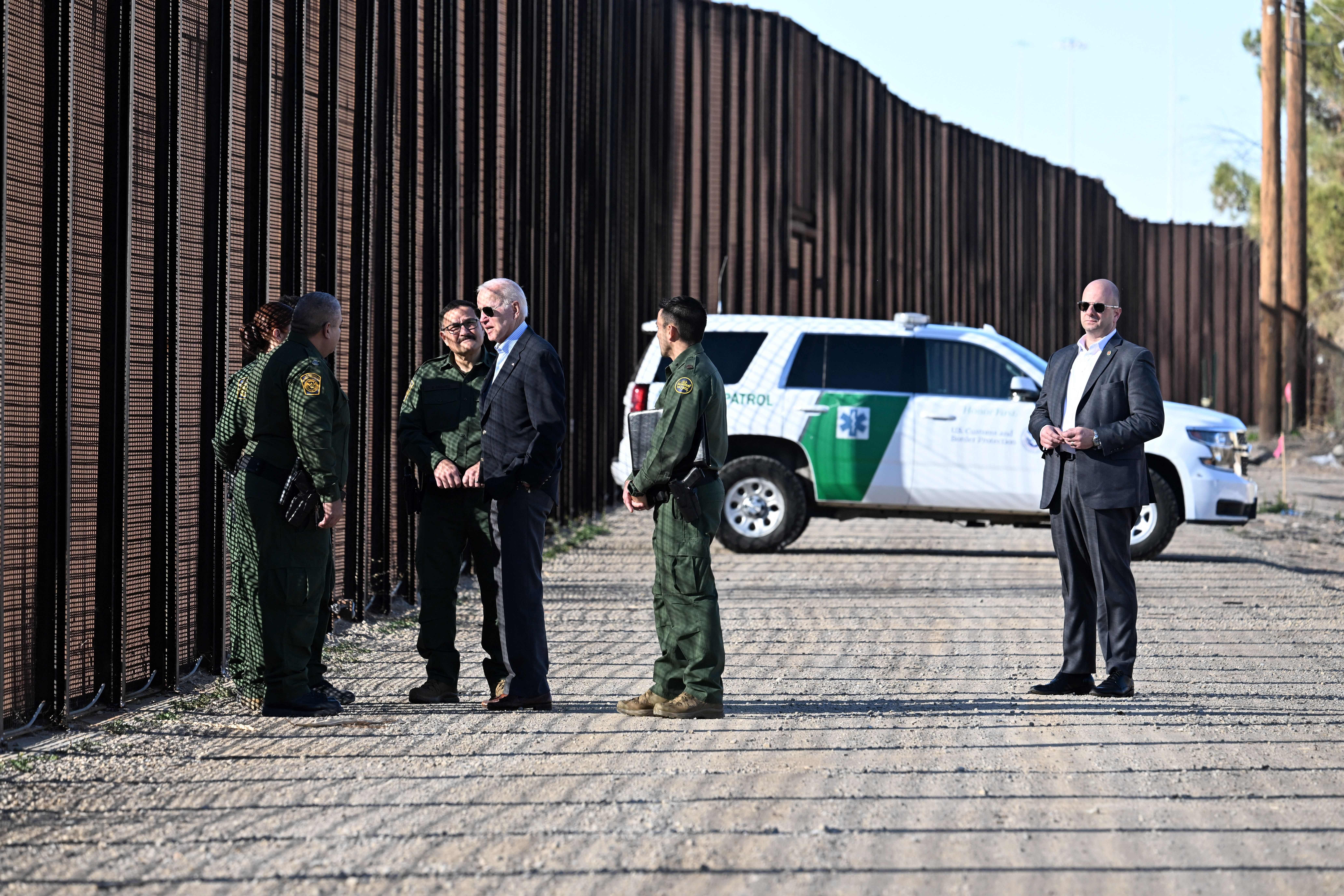 US President Joe Biden speaks with members of the US Border Patrol in front of the US-Mexico border fence in El Paso, Texas, on January 8, 2023. - Biden went to t e US-Mexico border on Sunday for the first time since taking office, visiting an El Paso, Texas entry point at the center of debates over illegal immigration and smuggling. (Photo by Jim WATSON / AFP) (Photo by JIM WATSON/AFP via Getty Images)