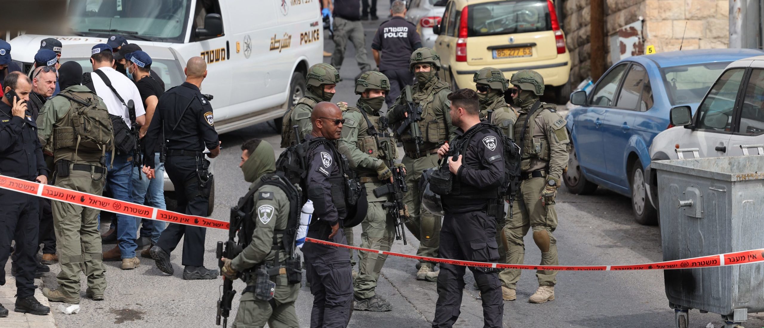 Israeli security forces and emergency service personnel gather at a cordoned-off area in Jerusalem's predominantly Arab neighbourhood of Silwan, where an assailant reportedly shot and wounded two people, on January 28, 2023. (Photo by AHMAD GHARABLI/AFP via Getty Images)
