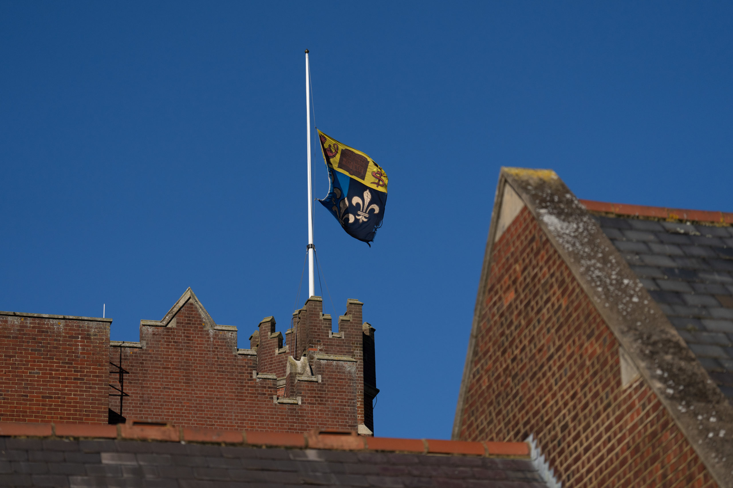EPSOM, ENGLAND - FEBRUARY 06: A flag flies at half mast at Epsom College after the school's head, Emma Pattison, was found dead alongside her family yesterday, on February 6, 2023 in Epsom, England. Pattison, her husband George, and 7-year-old daughter Emma were found dead in a property on school grounds early on Sunday morning. (Photo by Carl Court/Getty Images)
