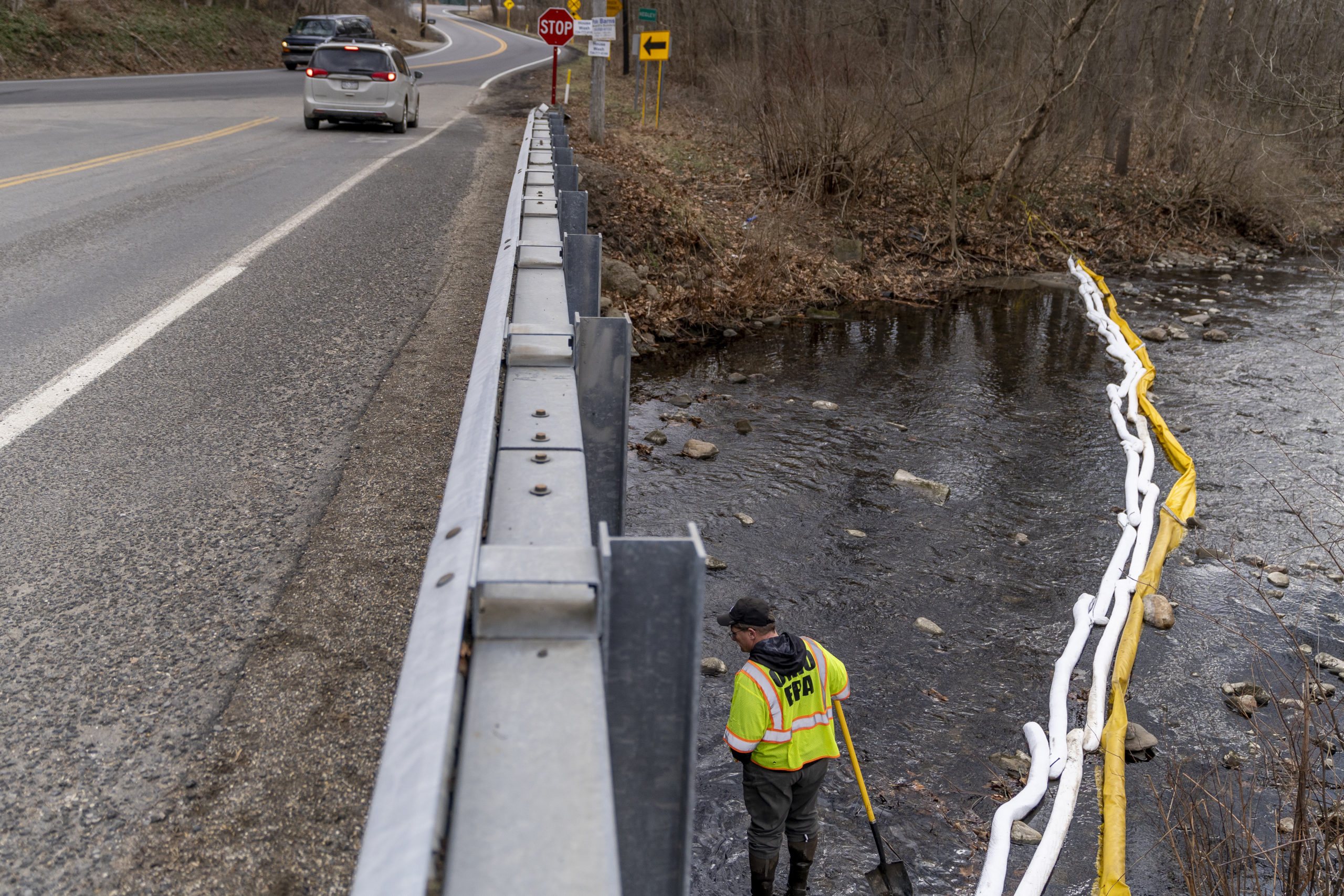 Ron Fodo, Ohio EPA Emergency Response, looks for signs of fish and also agitates the water in Leslie Run creek to check for chemicals that have settled at the bottom following the train derailment prompting health concerns on February 20, 2023 in East Palestine, Ohio. 