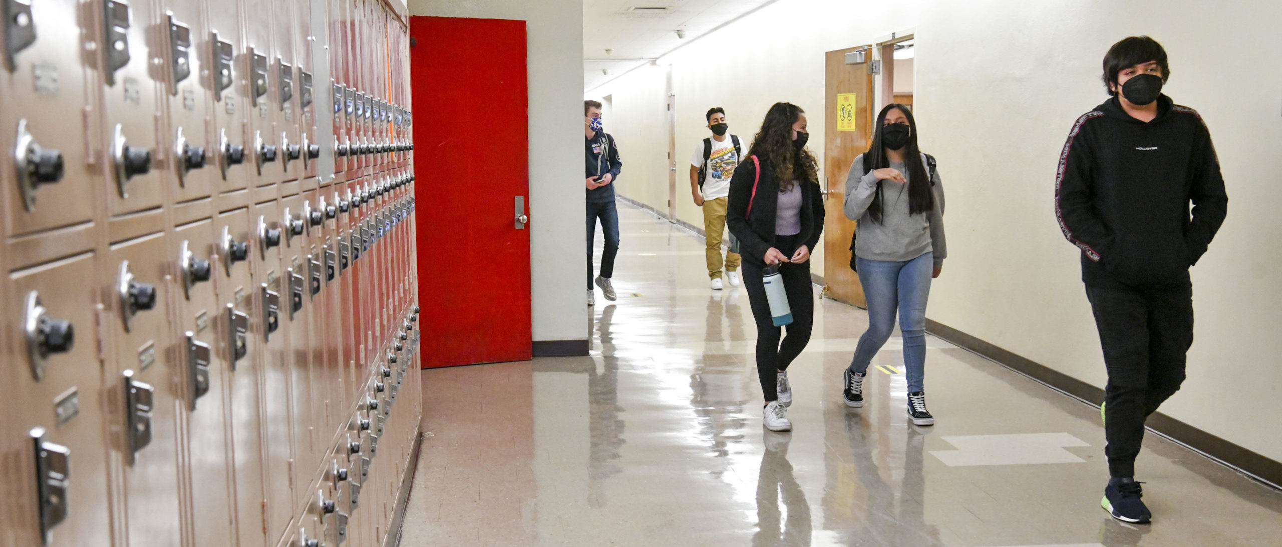 Returning students walk the hallway at Hollywood High School on April 27, 2021 in Los Angeles, California. Los Angeles Unified School District middle and high schools have reopened this week for in-person instruction. COVID-19 protocols in place include testing for all students and staff, vaccinations for all staff, and a completed daily health check for anyone arriving on campus (Photo by Rodin Eckenroth/Getty Images)
