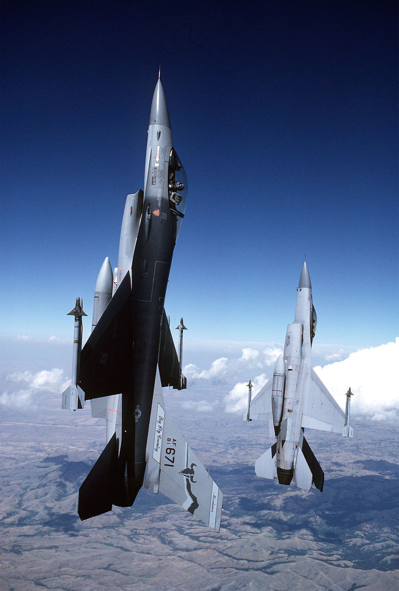 FILE PHOTO:Armed with AIM-9 Sidewinder missiles, a pair of F-16A Fighting Falcon aircraft of the 120th Fighter Interceptor Group, Montana Air National Guard, climb skyward at a 90 degree angle while flying a mission near Great Falls International Airport.