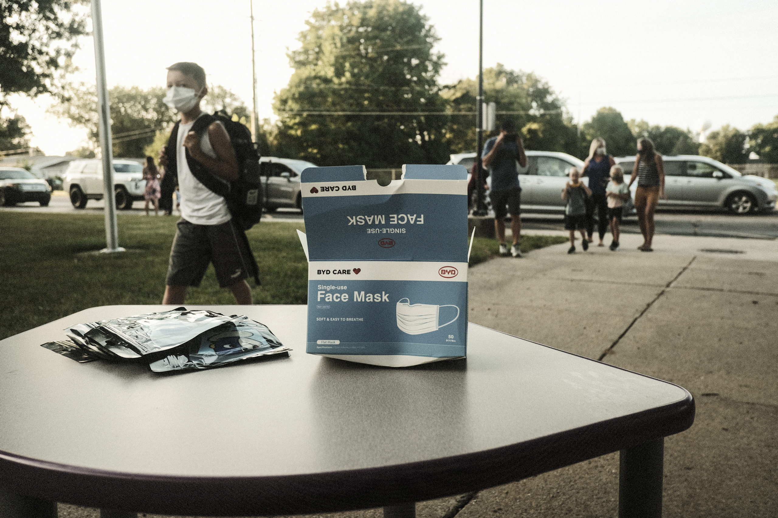 Face masks sit on a table outside of Schoolcraft Elementary for students and parents to wear when entering the building on the first day of school on August 30, 2021 in Schoolcraft, Michigan. The Schoolcraft Community School district, like many school districts throughout the country are adapting to mask mandates for teachers and students due to the current surge of Covid-19 cases. (Photo by Matthew Hatcher/Getty Images)