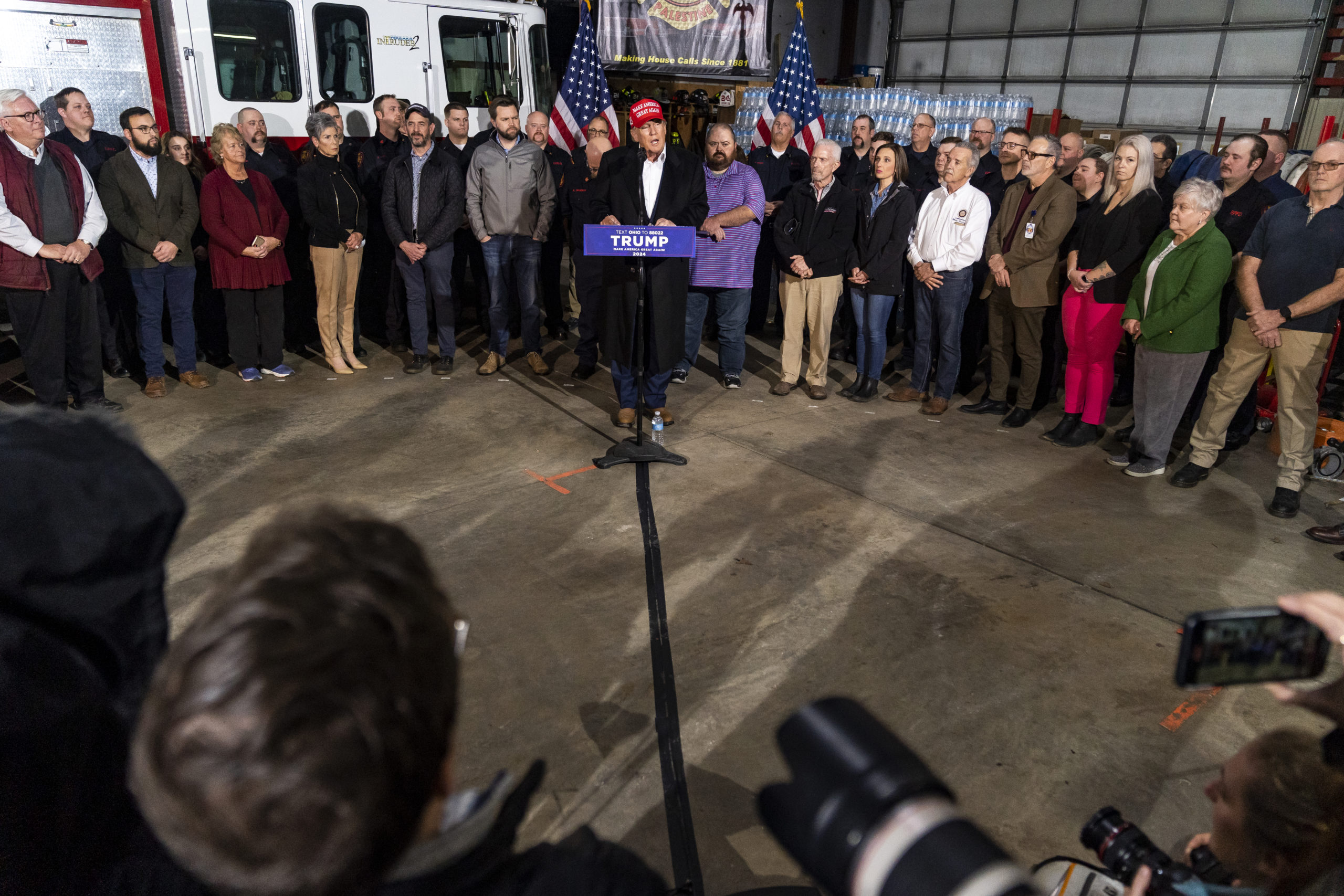 Former President Donald Trump stands next to a pallet of water before delivering remarks at the East Palestine Fire Department station on February 22, 2023 in East Palestine, Ohio.