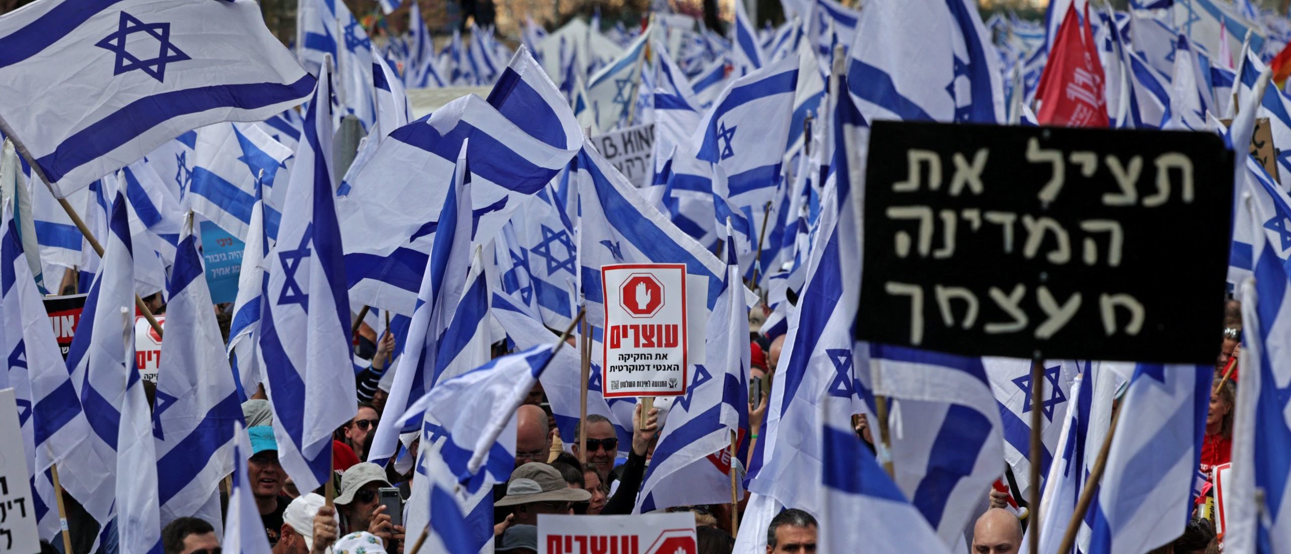 Protesters gather with placards and national flags outside Israel's parliament in Jerusalem amid ongoing demonstrations and calls for a general strike against the hard-right government's controversial push to overhaul the justice system, on March 27, 2023. (Photo by HAZEM BADER/AFP via Getty Images)