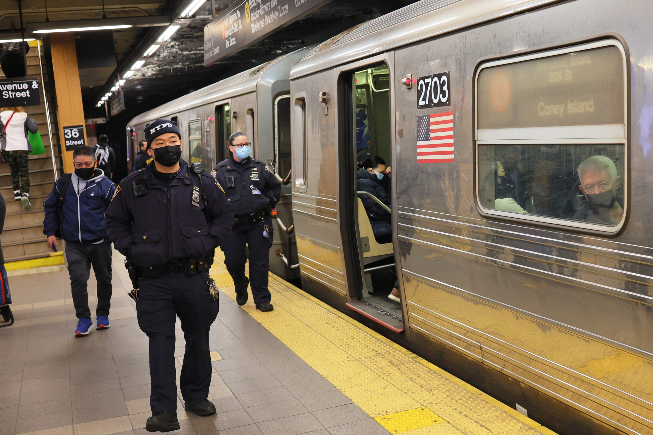 NEW YORK, NEW YORK - APRIL 13: NYPD officers patrol the subway platform at the 36 Street subway station on April 13, 2022 in the Sunset Park neighborhood of Brooklyn in New York City. A manhunt is underway for a gunman who shot 10 people, critically injuring five on the N train during Tuesday's morning rush hour. The suspect, wearing a gas mask, tossed smoke grenades on the floor and fired 33 shots before leaving the scene. At least 13 other commuters suffered injuries due to smoke inhalation, falls, and panic attacks. The police on Tuesday evening named a "person of interest" in the mass shooting and believe that they have found his personal belongings left on the train that includes a Glock 9-millimeter handgun and a key to a U-Haul van. Mayor Eric Adams this morning announced that Frank James, the "person of interest" is now considered a suspect. (Photo by Michael M. Santiago/Getty Images)