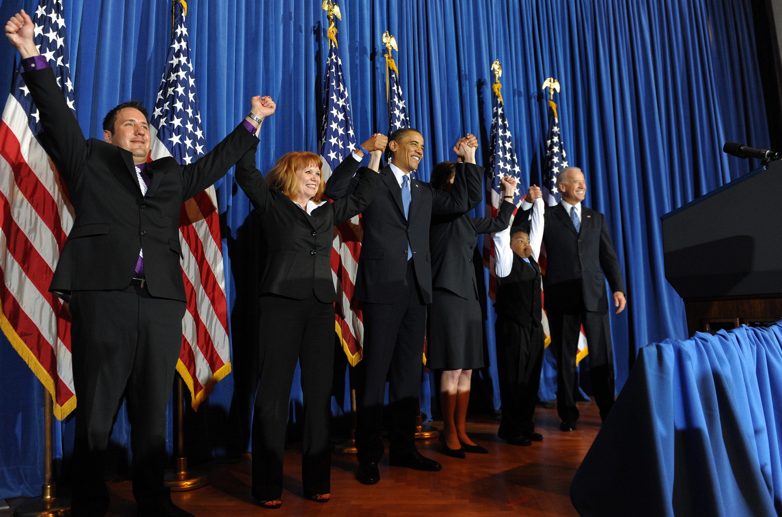 US President Barack Obama (C) celebrates with lawmakers after holding a rally celebrating the passage and signing into law of the Patient Protection and Affordable Care Act health insurance reform bill, at the Interior Department in Washington, DC, on March 23, 2010. Obama signed into law his historic health care reform, enacting the most sweeping social legislation in decades which will ensure coverage for almost all Americans. AFP PHOTO/Jewel SAMAD (Photo credit should read JEWEL SAMAD/AFP via Getty Images)