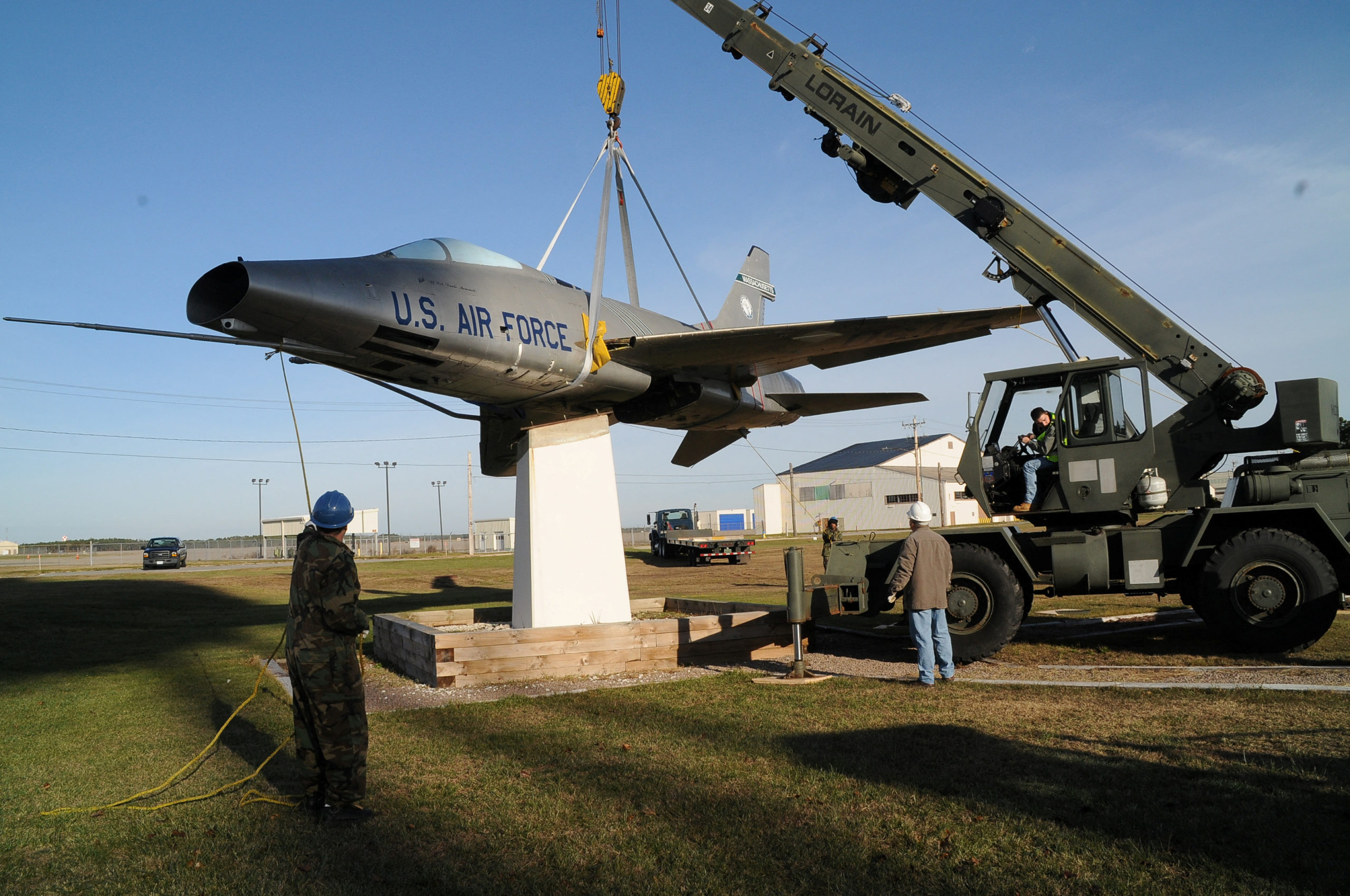 An exhibit specialist in aircraft restoration assists the 102nd Intelligence Wing Civil Engineers with the removal of an F-100 static aircraft at Otis Air National Guard Base in Cape Cod, Massachusetts, U.S. November 30, 2010. Master Sgt. Sandra Niedzwiecki/U.S. Air Force/Handout via REUTERS THIS IMAGE HAS BEEN SUPPLIED BY A THIRD PARTY.