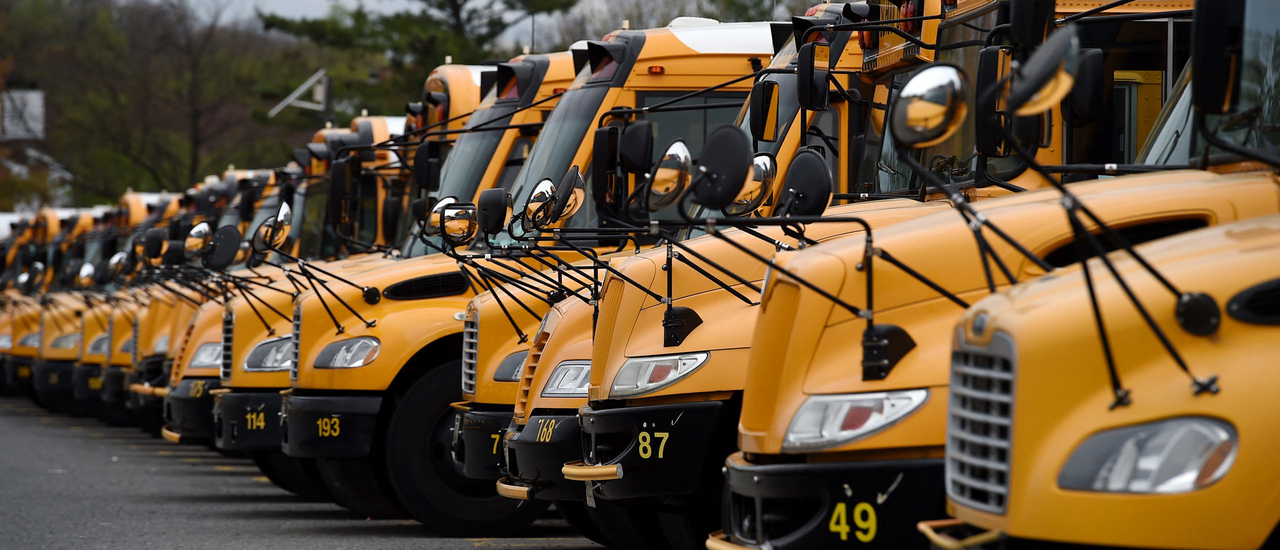 About 100 school buses are parked at the Arlington County Bus Depot, in response to the novel coronavirus, COVID-19 outbreak on March 31, 2020 in Arlington, Virginia. (Photo by Olivier DOULIERY / AFP) (Photo by OLIVIER DOULIERY/AFP via Getty Images)