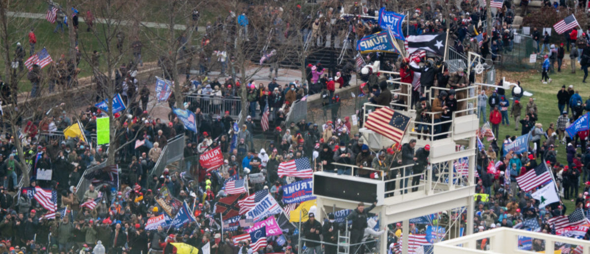 Supporters of US President Donald Trump take over stands set up for the presidential inauguration as they protest at the US Capitol in Washington, DC, January 6, 2021. - Thousands of Trump supporters, fueled by his spurious claims of voter fraud, are flooding the nation's capital protesting the expected certification of Joe Biden's White House victory by the US Congress. (Photo by SAUL LOEB / AFP) (Photo by SAUL LOEB/AFP via Getty Images)