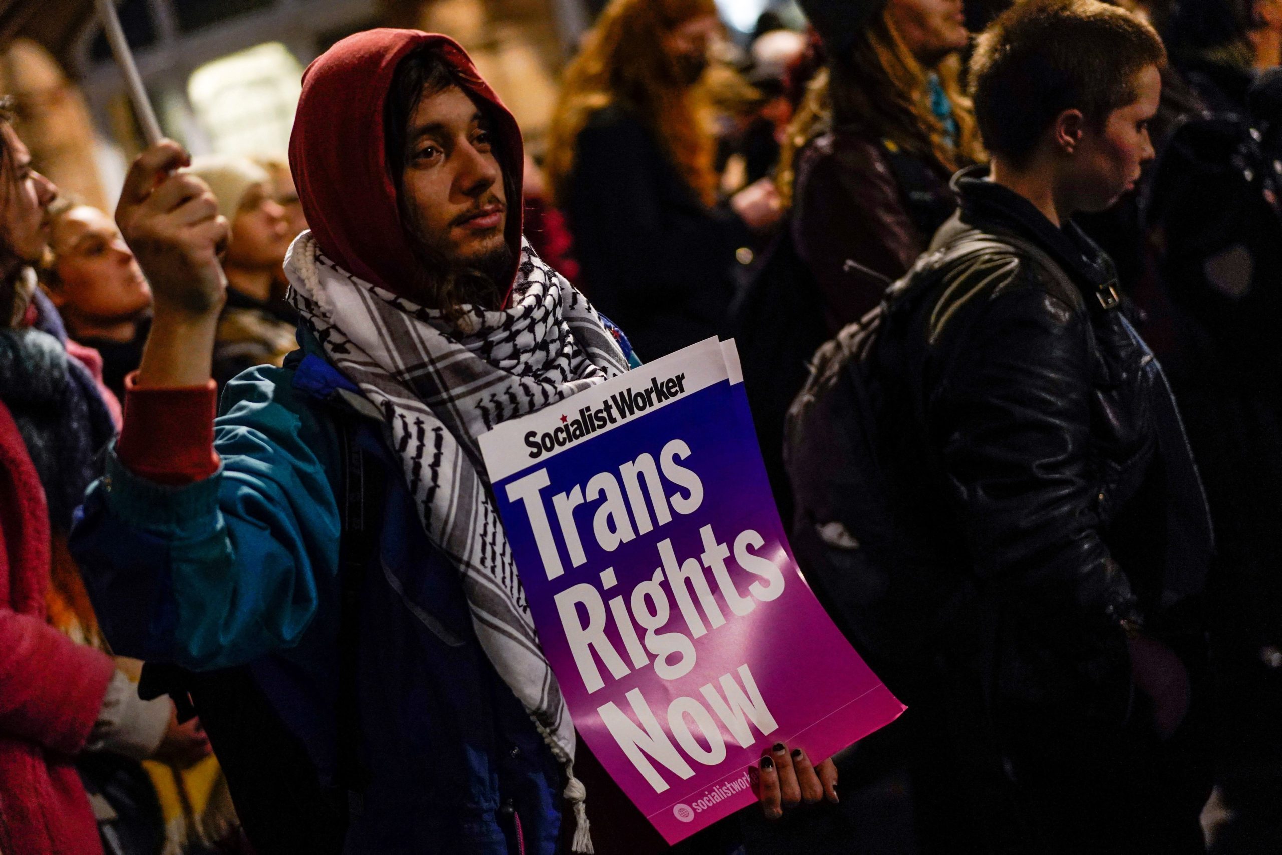 A person hols a placard while taking part in a vigil, in London, on February 15, 2023 in tribute of 16-year-old transgender teen, Brianna Ghey, stabbed to death. - Brianna Ghey was fatally stabbed in Warrington, northwest England, on February 11, 2023. Members of the public found her on a path in a park that afternoon. Cheshire Police arrested two 15-year-olds, a boy and a girl, from nearby Leigh, on Sunday and on Wednesday charged them with her murder. (Photo by Niklas HALLE'N / AFP) (Photo by NIKLAS HALLE'N/AFP via Getty Images)